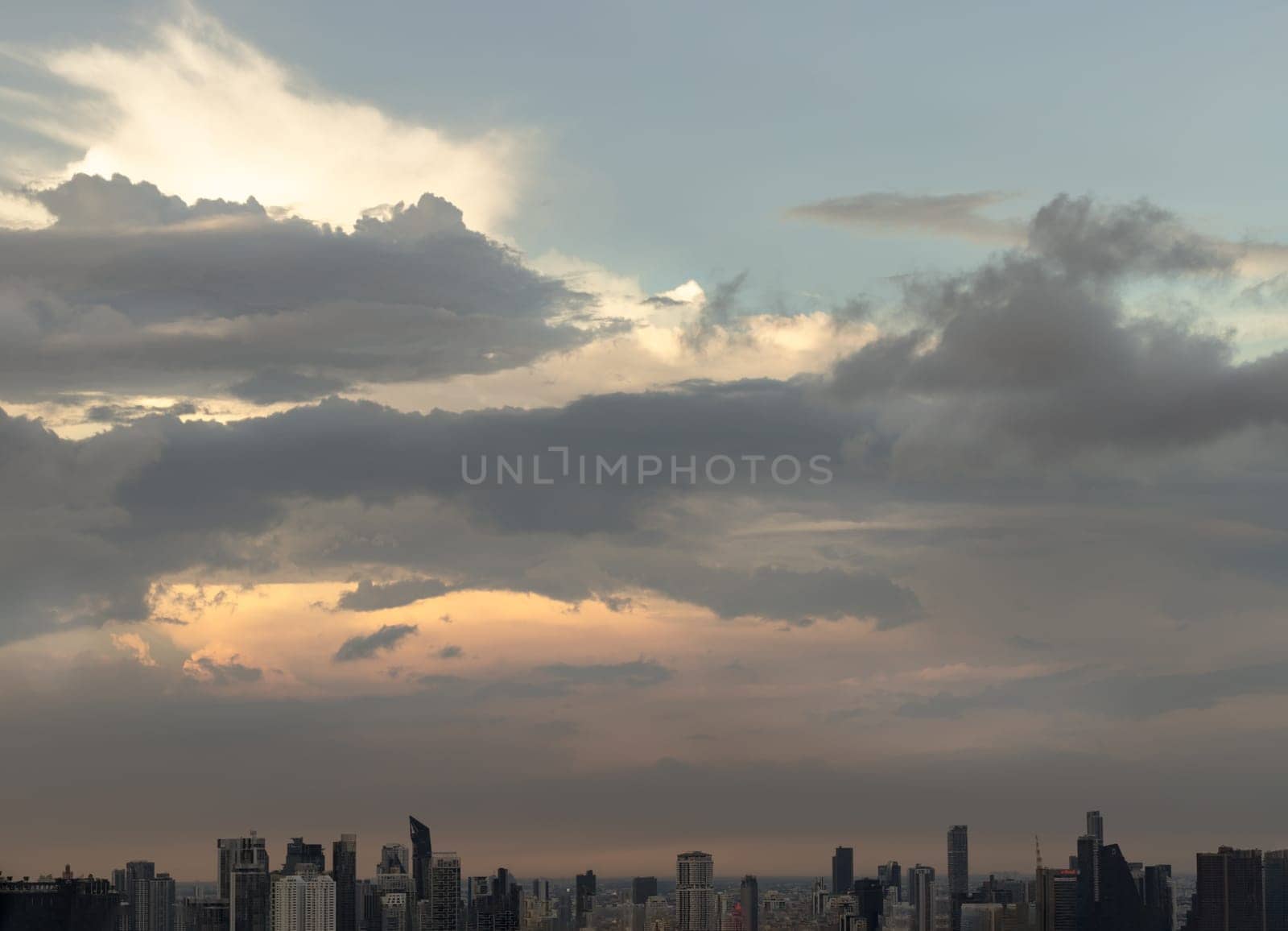 Bangkok, Thailand - 04 Aug 2024 - Beautiful Clouds in the Sky over Large Metropolitan City of Bangkok. View of Skyscrapers and Dramatic Sky before Sunset, Space for text, Selective focus.