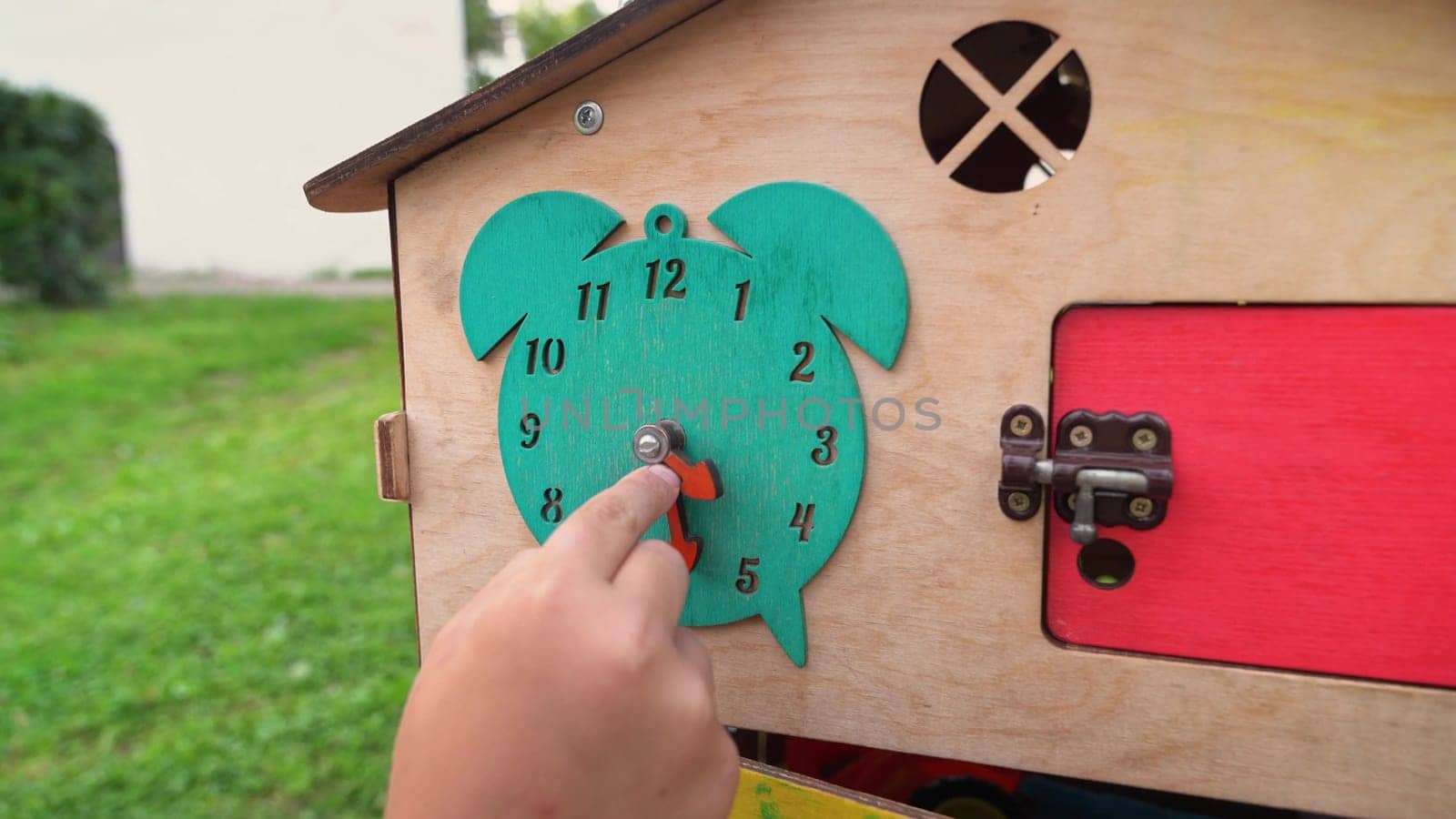 Child learns to tell time with a colorful, interactive toy.