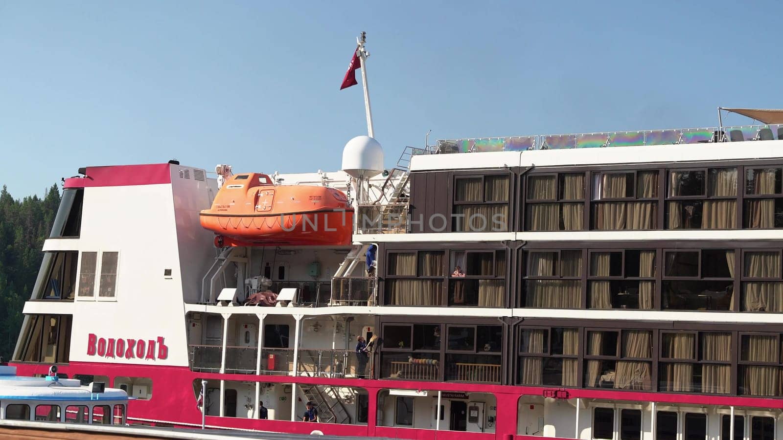Russia, Valaam Island , July 27, 2024 -luxury river cruise ship is docked while guests relax onboard.