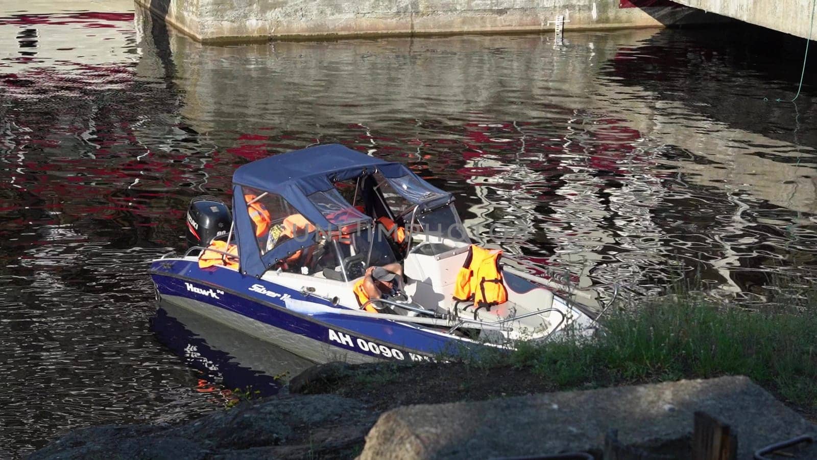 Russia, Valaam Island , July 27, 2024 -boat is securely docked, displaying safety gear and reflections.