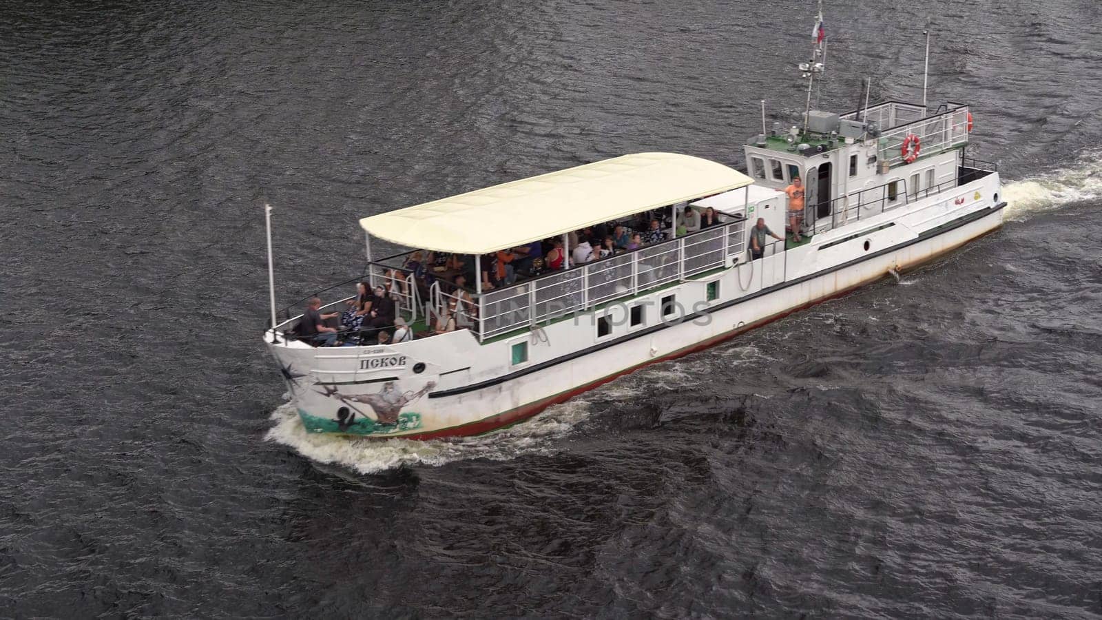 Russia, Pskov, July 19, 2024 - A group of passengers enjoy a leisurely boat ride on the river