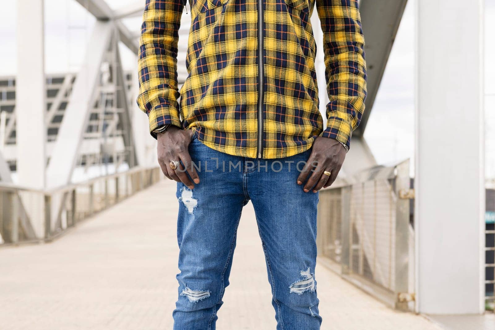 central body part of an unrecognizable young black man with his hands in his pockets, lifestyle concept