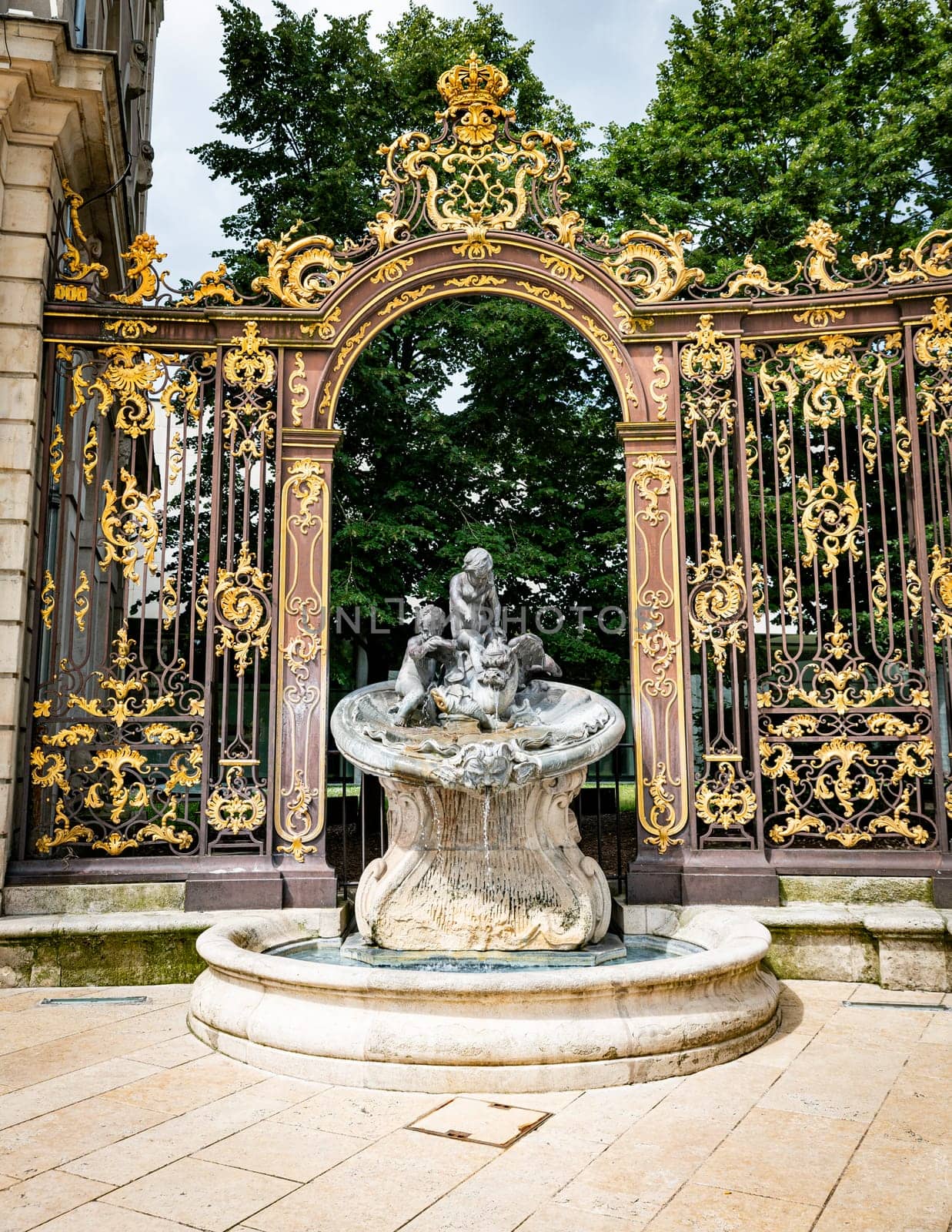 Gates and fountains in Stanislas Place - Nancy - France. One of the ornate gates and fountains in Stanislas Place in the historic center of the city of Nancy in France. A UNESCO World Heritage Site