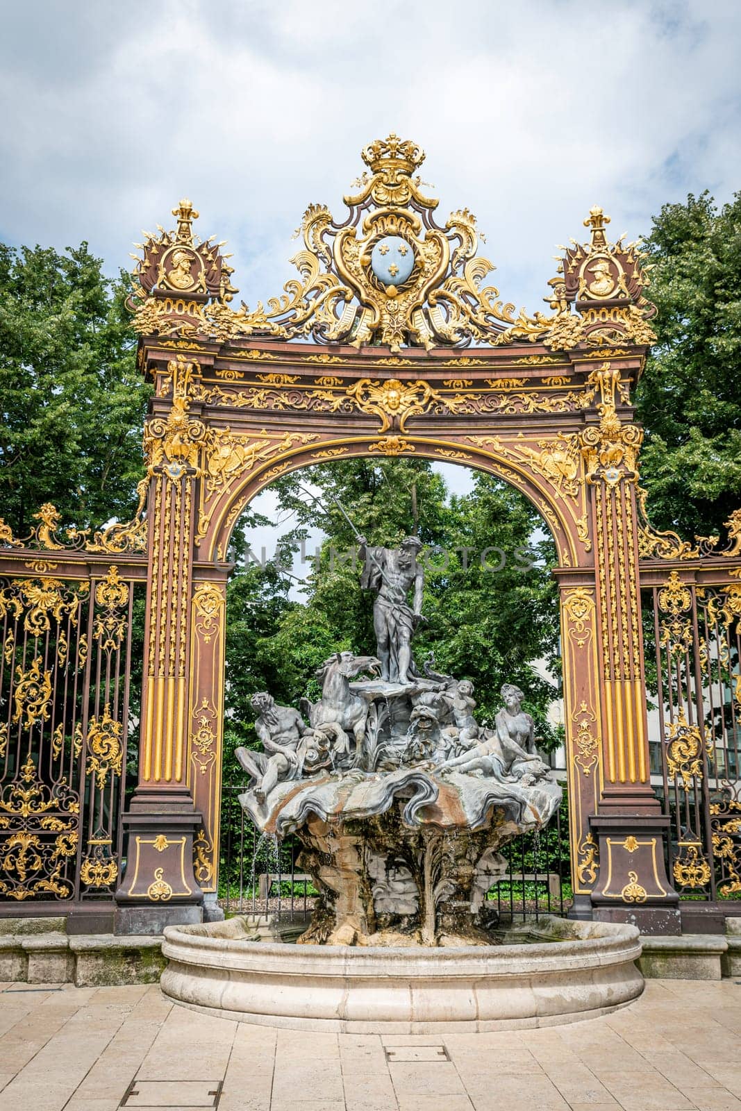 Gates and fountains in Stanislas Place - Nancy - France. One of the ornate gates and fountains in Stanislas Place in the historic center of the city of Nancy in France. A UNESCO World Heritage Site