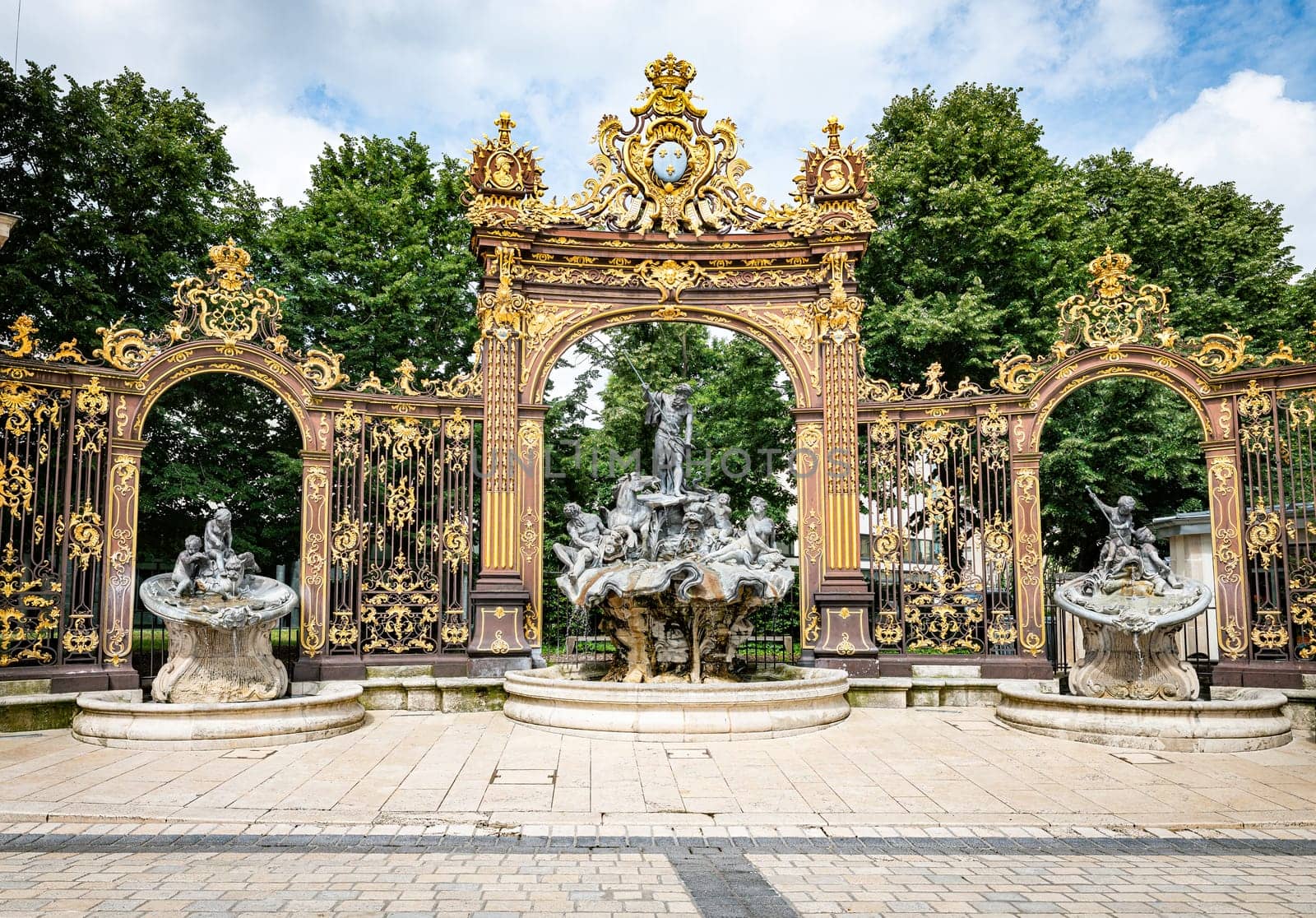 Gates and fountains in Stanislas Place - Nancy - France. One of the ornate gates and fountains in Stanislas Place in the historic center of the city of Nancy in France. A UNESCO World Heritage Site