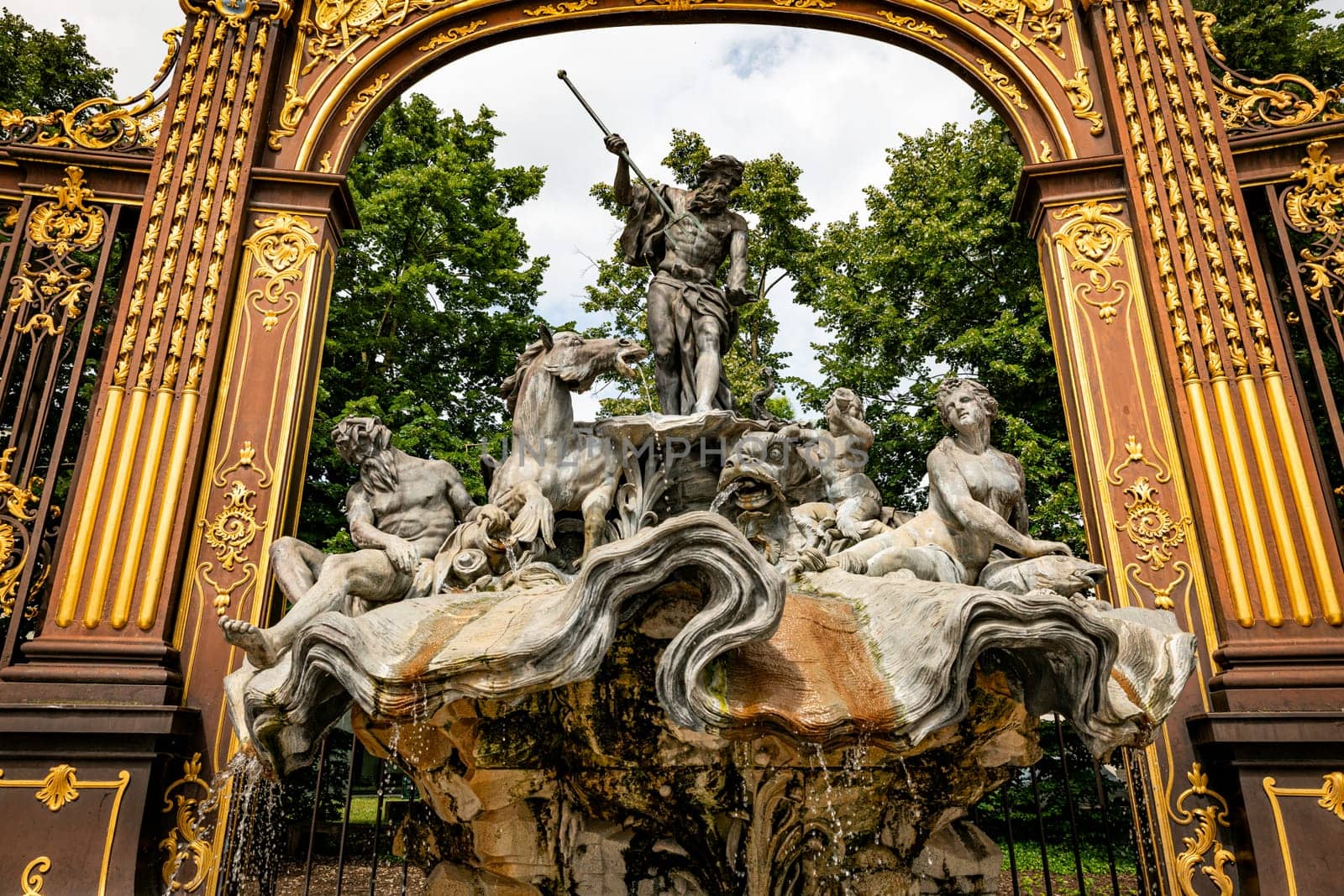Gates and fountains in Stanislas Place - Nancy - France. One of the ornate gates and fountains in Stanislas Place in the historic center of the city of Nancy in France. A UNESCO World Heritage Site
