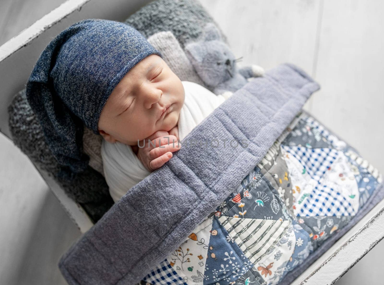 Newborn Baby Sleeps During Photoshoot In Tiny Crib