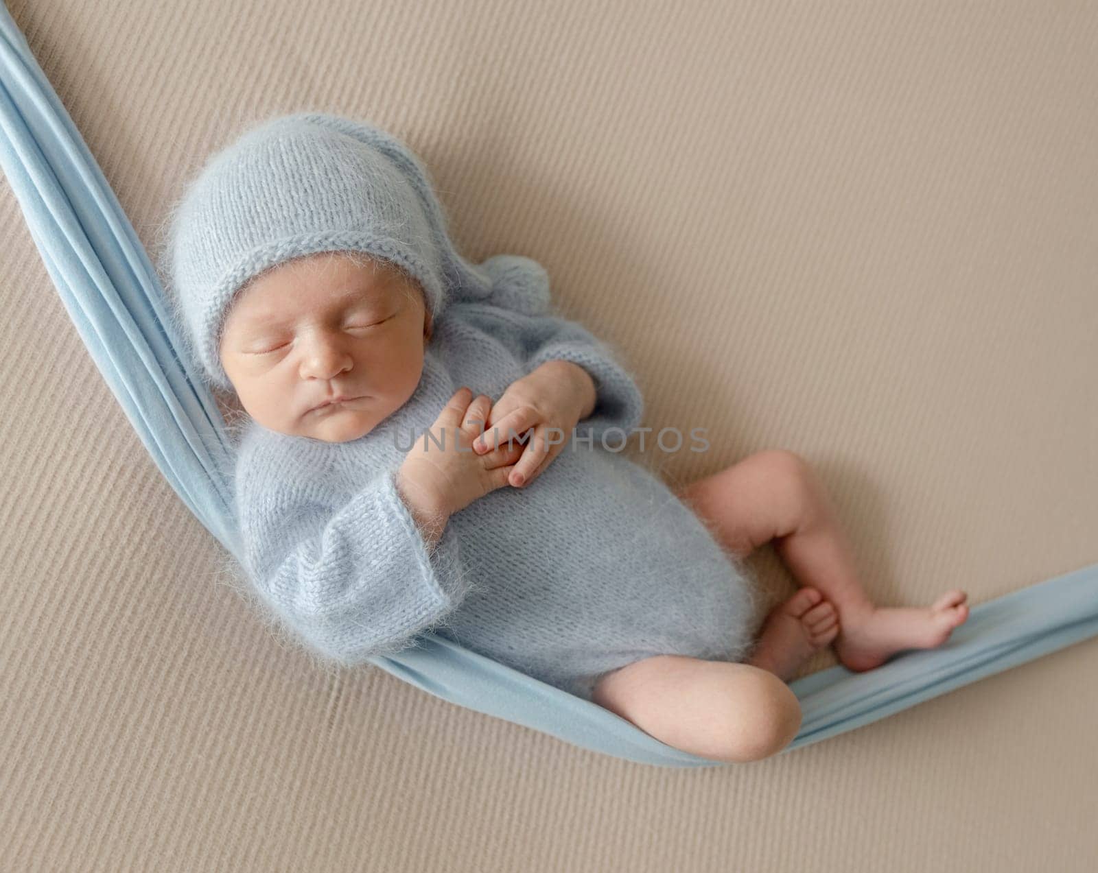 Newborn Baby Sleeps During Photo Session In Hammock