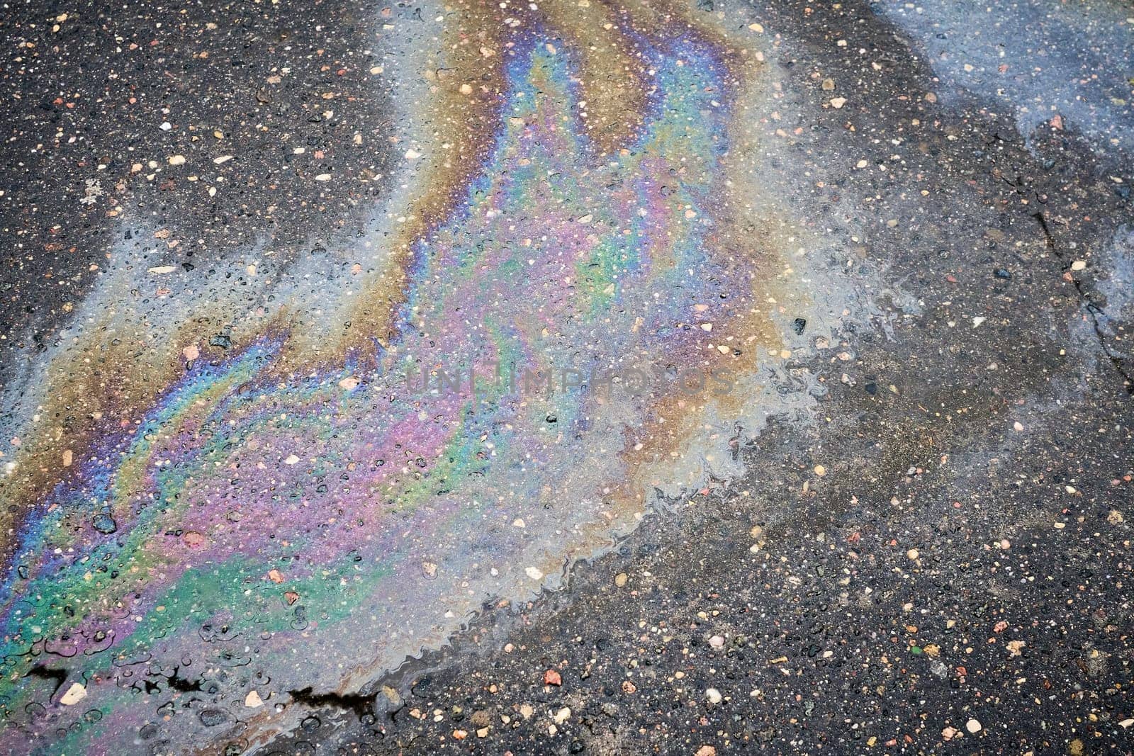 Overhead View of a Vibrant Oil Slick on Wet Asphalt
