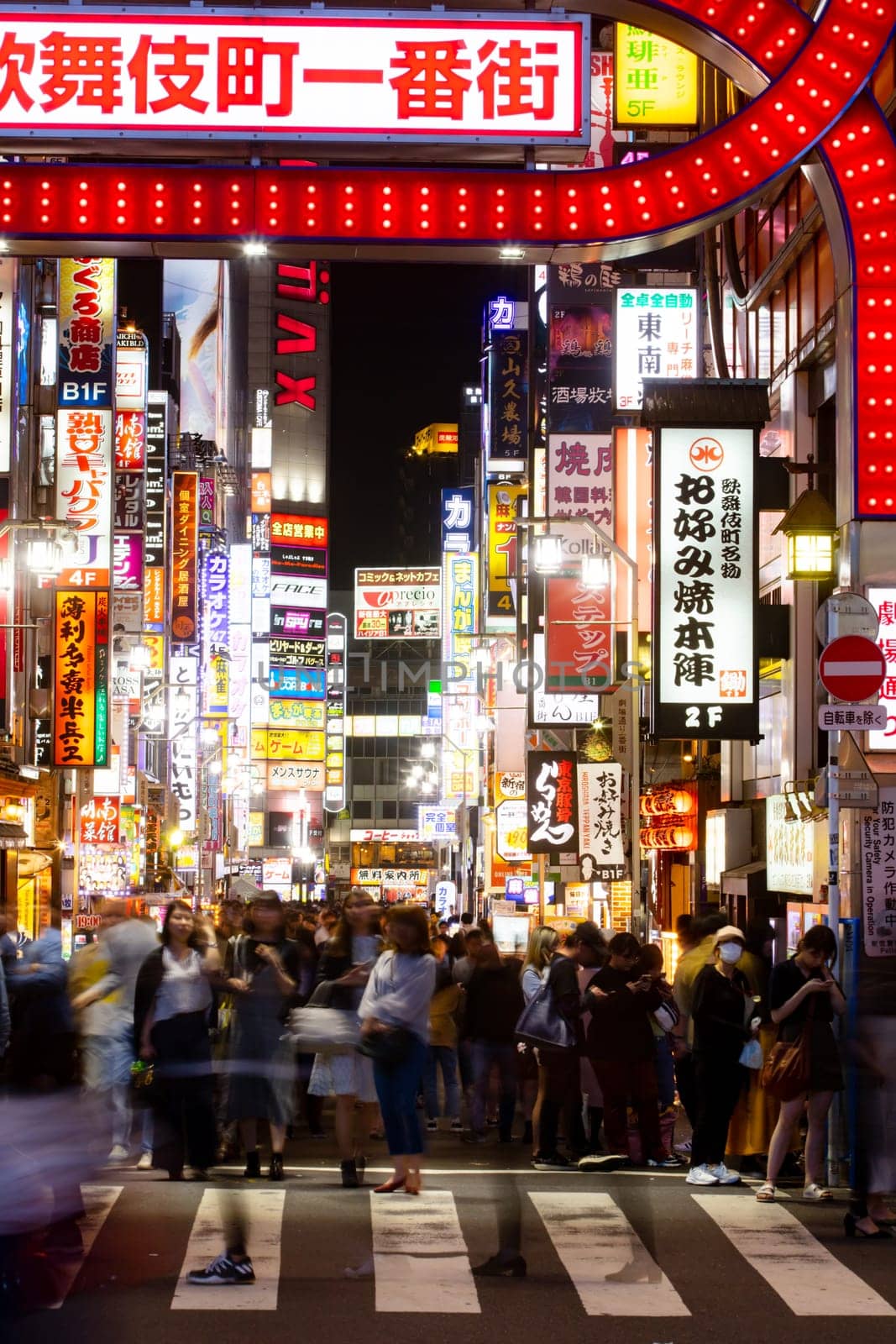 Shinjuku, Japan, 18 May 2019: Neon signs illuminate Tokyo’s busy Shinjuku neighborhood with crowds of people at night