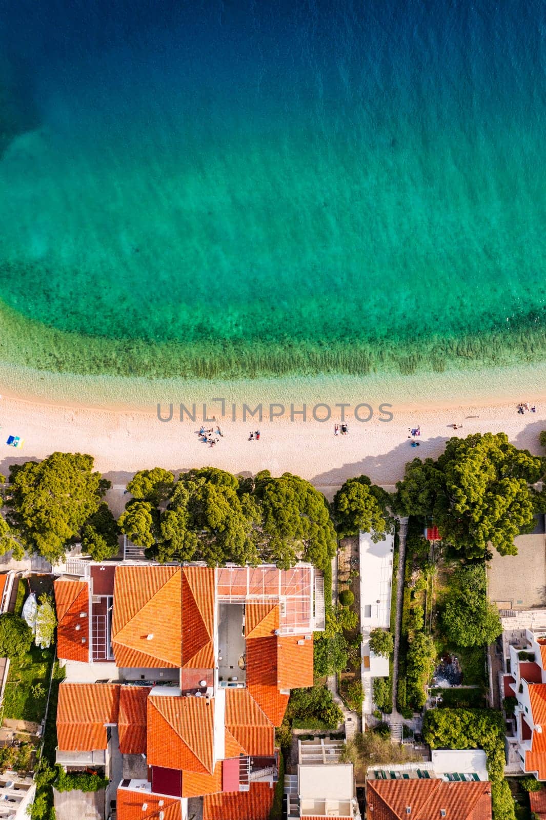 Beautiful Brela on Makarska riviera, Croatia. Adriatic Sea with amazing turquoise clean water and white sand. Aerial view of Brela beach and waterfront on Makarska riviera, Dalmatia region of Croatia.