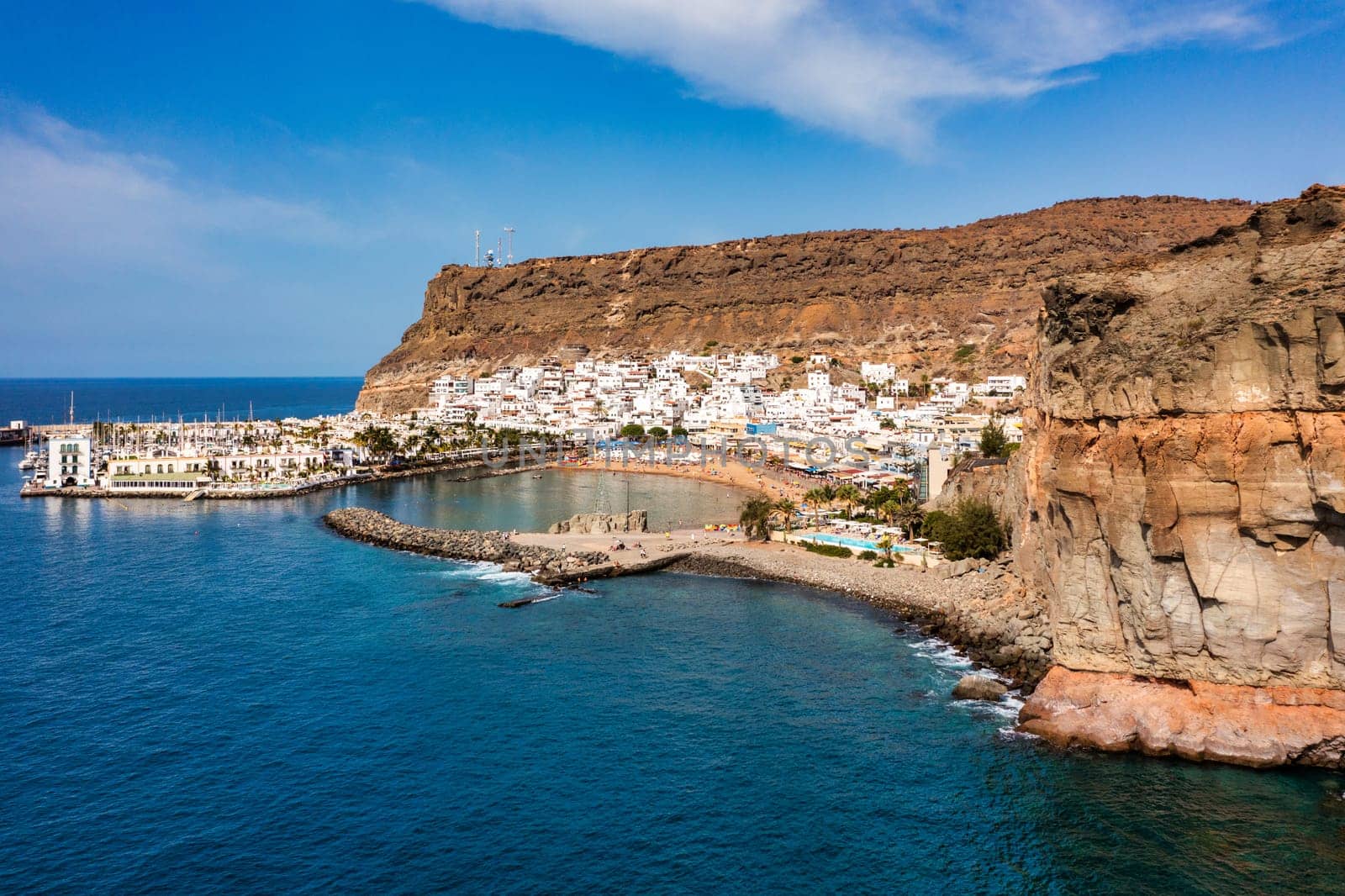 Puerto de Mogan with the beach in Gran Canaria, Spain. Favorite vacation place for tourists and locals on island. Harbor in Puerto de Mogan and Playa Mogan on Grand Canary Island, Spain.