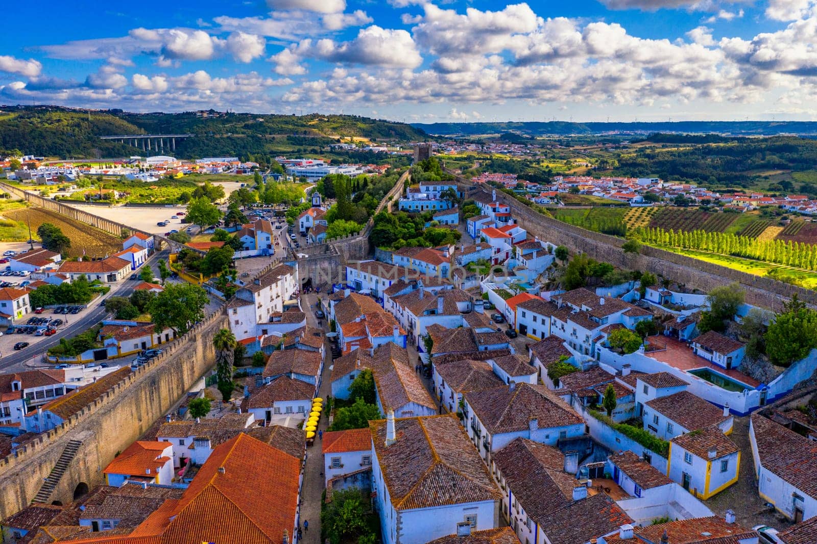 Aerial view of the historic walled town of Obidos at sunset, near Lisbon, Portugal. Aerial shot of Obidos Medieval Town, Portugal. Aerial view of medieval fortress in Obidos. Portugal.