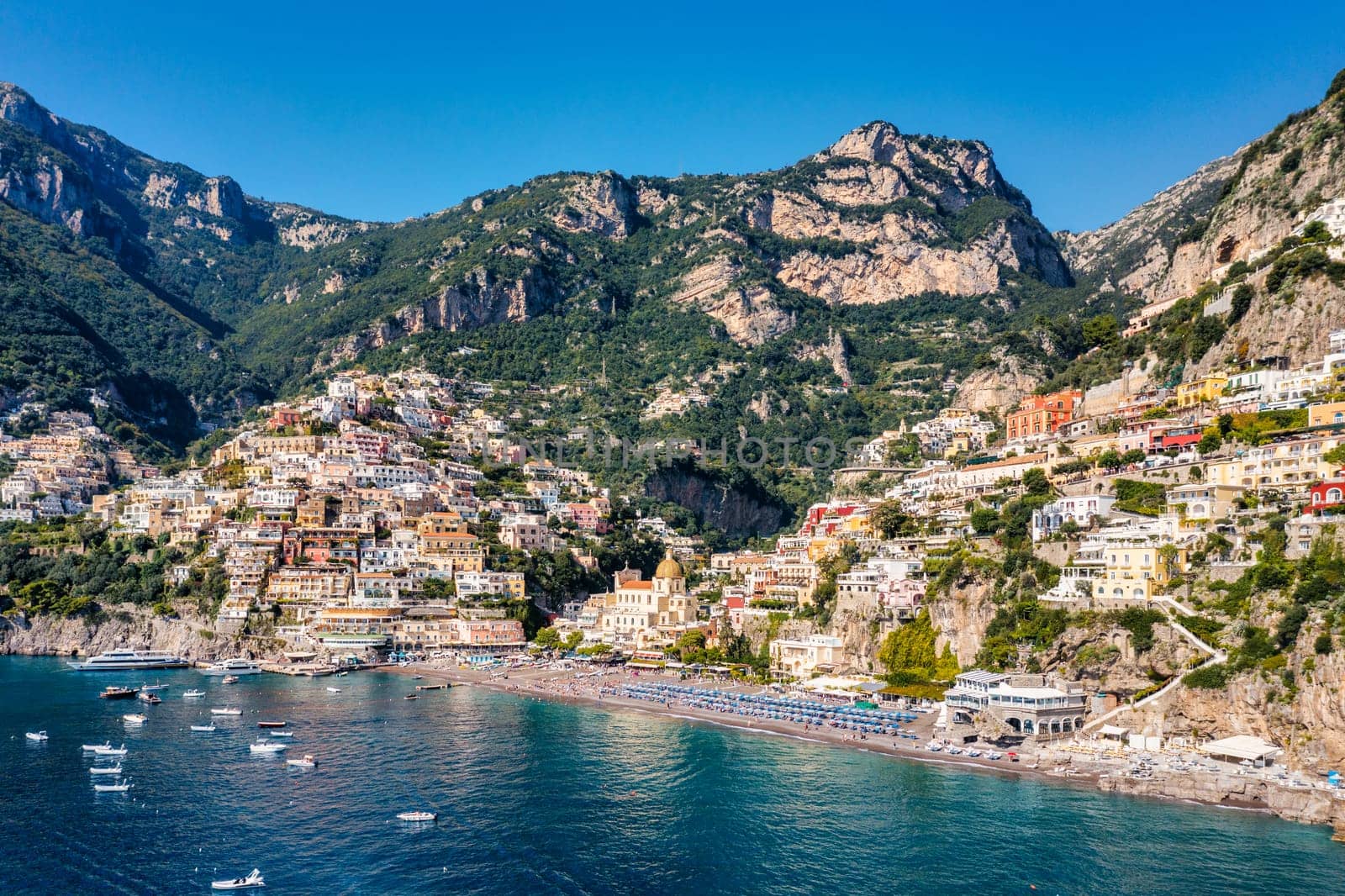 Aerial view of Positano with comfortable beach and blue sea on Amalfi Coast in Campania, Italy. Positano village on the Amalfi Coast, Salerno, Campania. Beautiful Positano, Amalfi Coast in Campania.