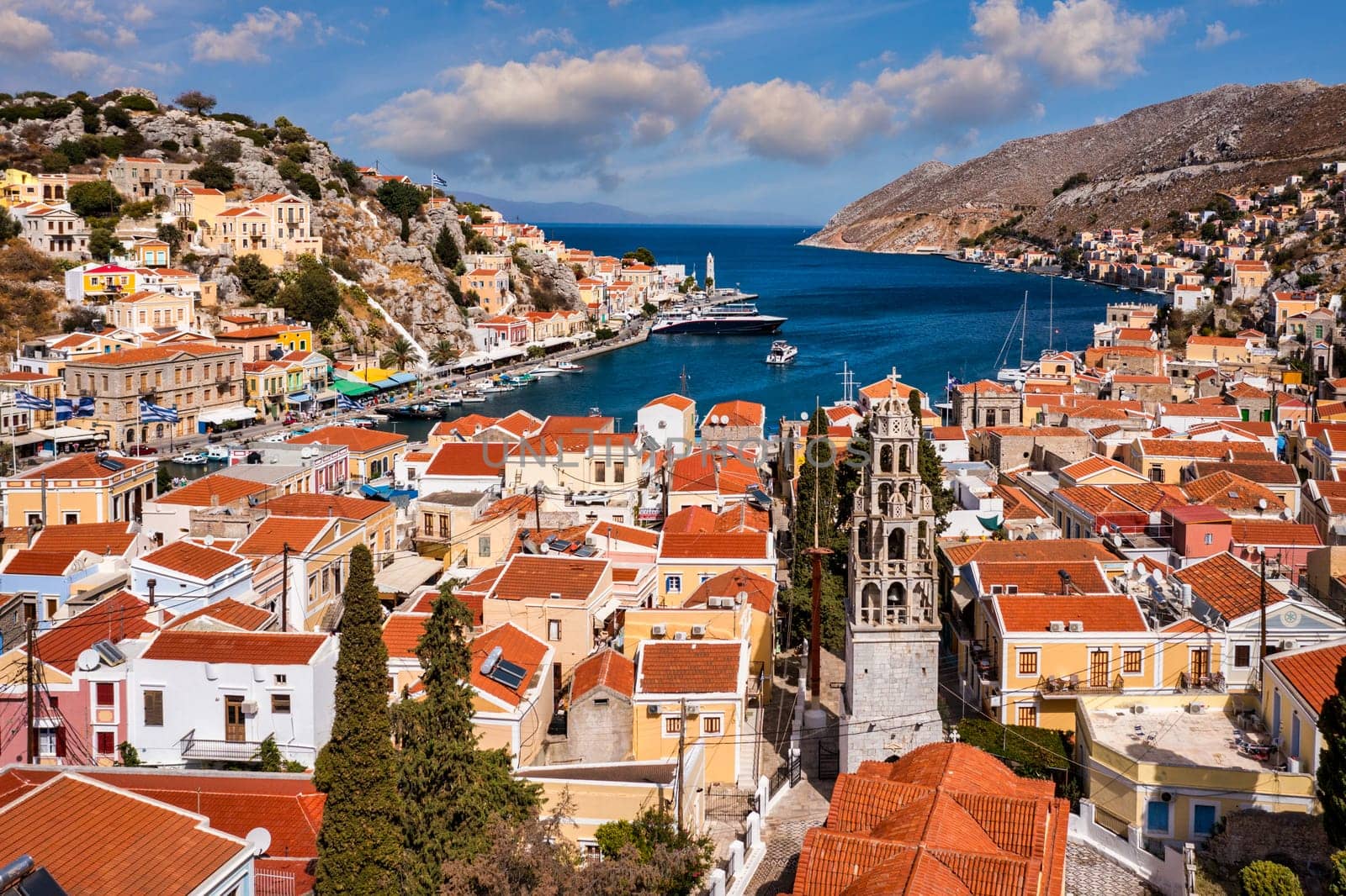 Aerial view of the beautiful greek island of Symi (Simi) with colourful houses and small boats. Greece, Symi island, view of the town of Symi (near Rhodes), Dodecanese.