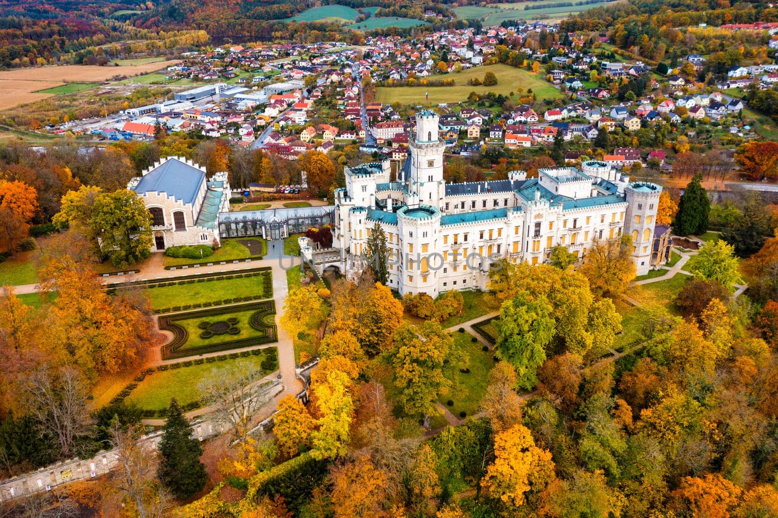 Castle Hluboka nad Vltavou is one of the most beautiful castles in Czech Republic. Castle Hluboka nad Vltavou in autumn with red foliage, Czechia. Colorful autumn view of Hluboka nad Vltavou castle.