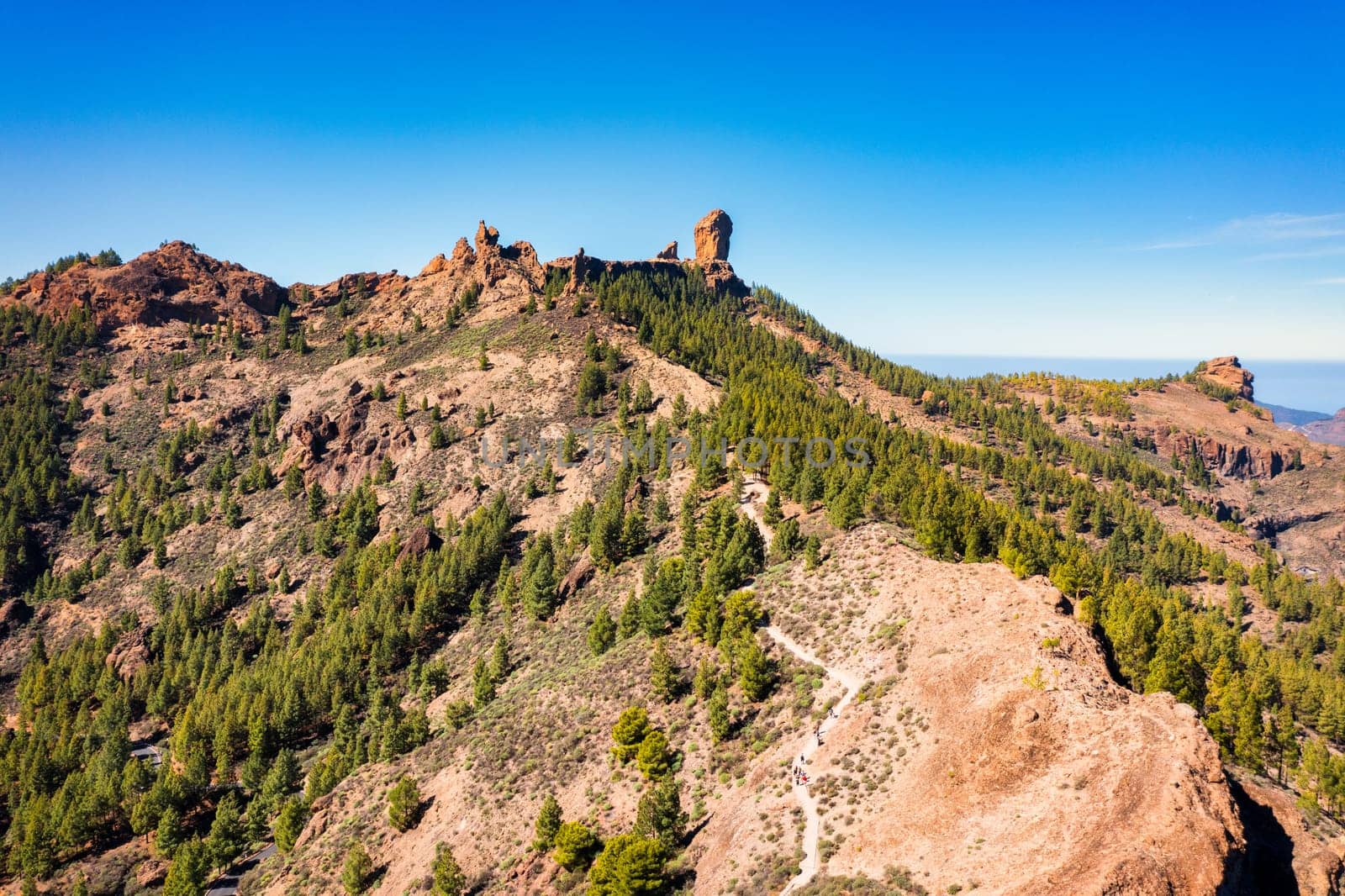 Roque Nublo and Pico de Teide in the background on Gran Canaria Island, Spain. Panoramic view of Roque Nublo sacred mountain, Roque Nublo Rural Park, Gran Canary, Canary Islands, Spain.
