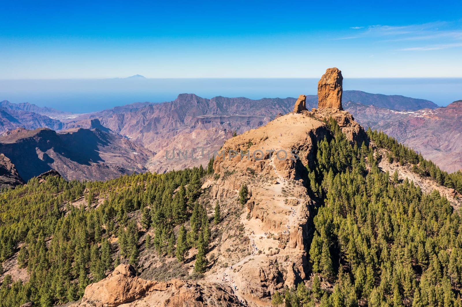 Roque Nublo and Pico de Teide in the background on Gran Canaria Island, Spain. Panoramic view of Roque Nublo sacred mountain, Roque Nublo Rural Park, Gran Canary, Canary Islands, Spain.
