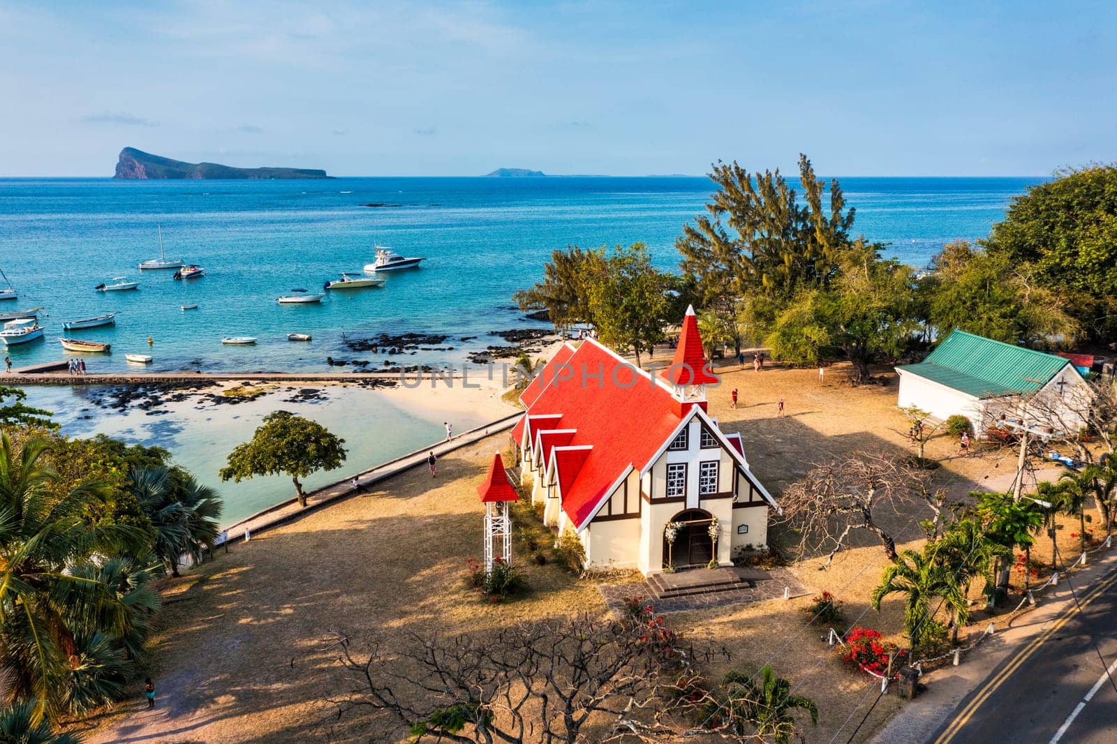 Red church at Cap Malheureux village, Mauritius Island. Notre Dame de Auxiliatrice, rural church with red roof in Cap Malheureux tropical village on Mauritius island, Indian Ocean.
