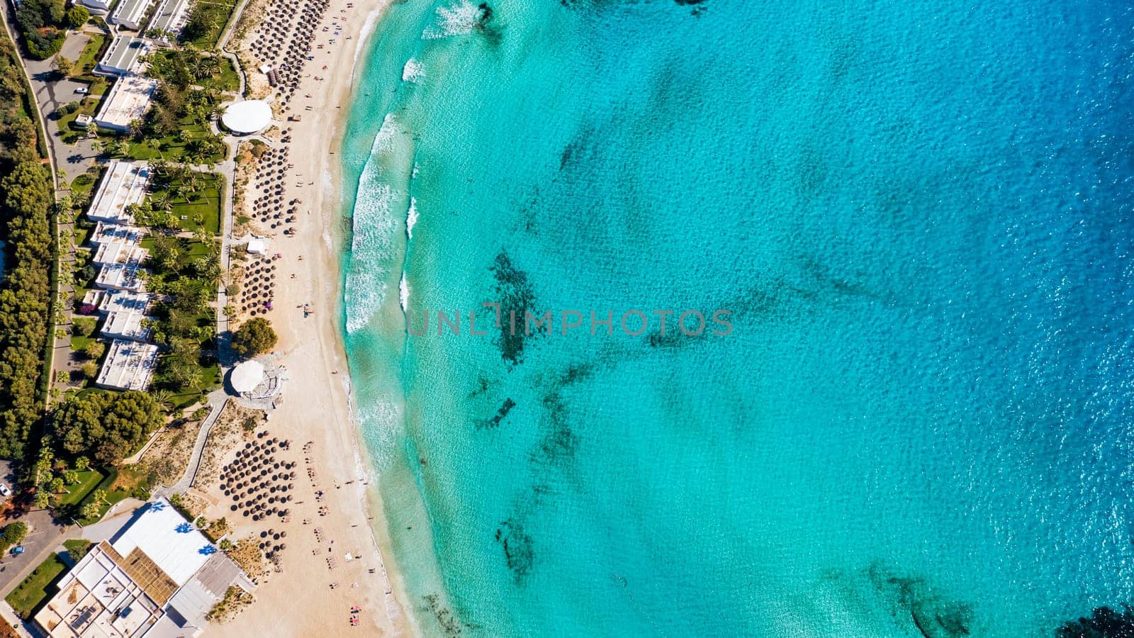 Aerial view of beautiful Nissi beach in Ayia Napa, Cyprus. Nissi beach in Ayia Napa famous tourist beach in Cyprus. A view of a azzure water and Nissi beach in Aiya Napa, Cyprus.