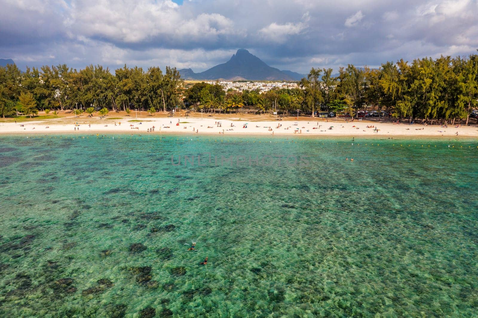 Beach of Flic en Flac with beautiful peaks in the background, Mauritius. Beautiful Mauritius Island with gorgeous beach Flic en Flac, aerial view from drone. Flic en Flac Beach, Mauritius Island.