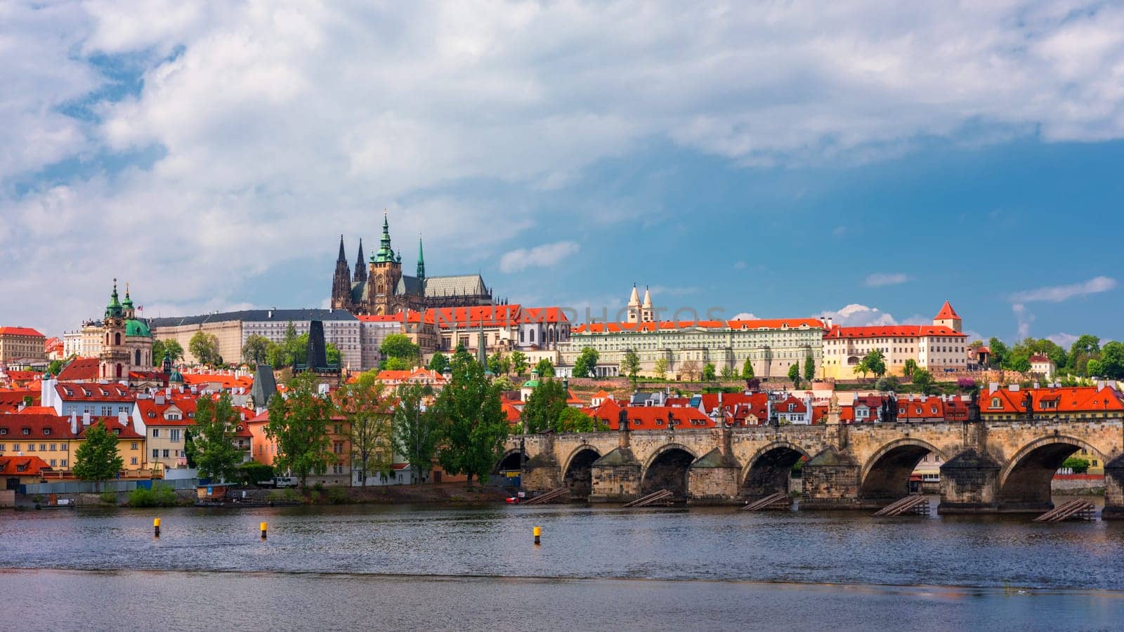 Prague scenic spring view of the Prague Old Town pier architecture Charles Bridge over Vltava river in Prague, Czechia. Old Town of Prague with the Castle in the background, Czech Republic.
