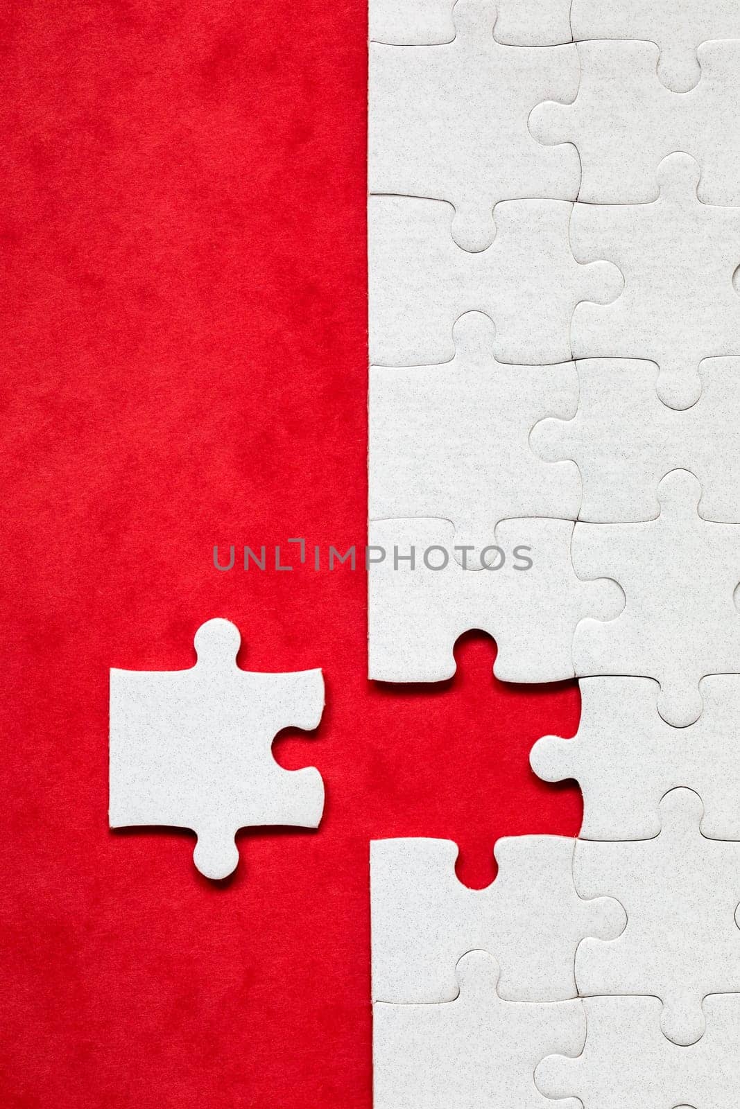 White jigsaw puzzle. White puzzle pieces on color background. Unfinished white jigsaw puzzle pieces on color background. 