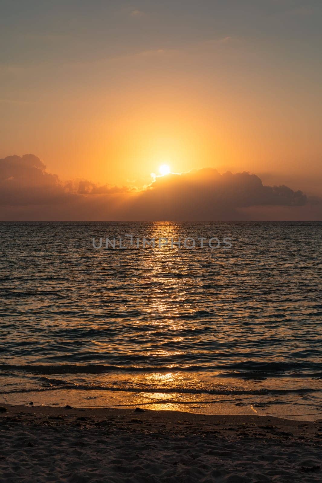 Dramatic colorful sunset sky over sea. Cloudscape nature background. Beautiful sunset over the sea. Sunset over the sea and beautiful cloudscape.