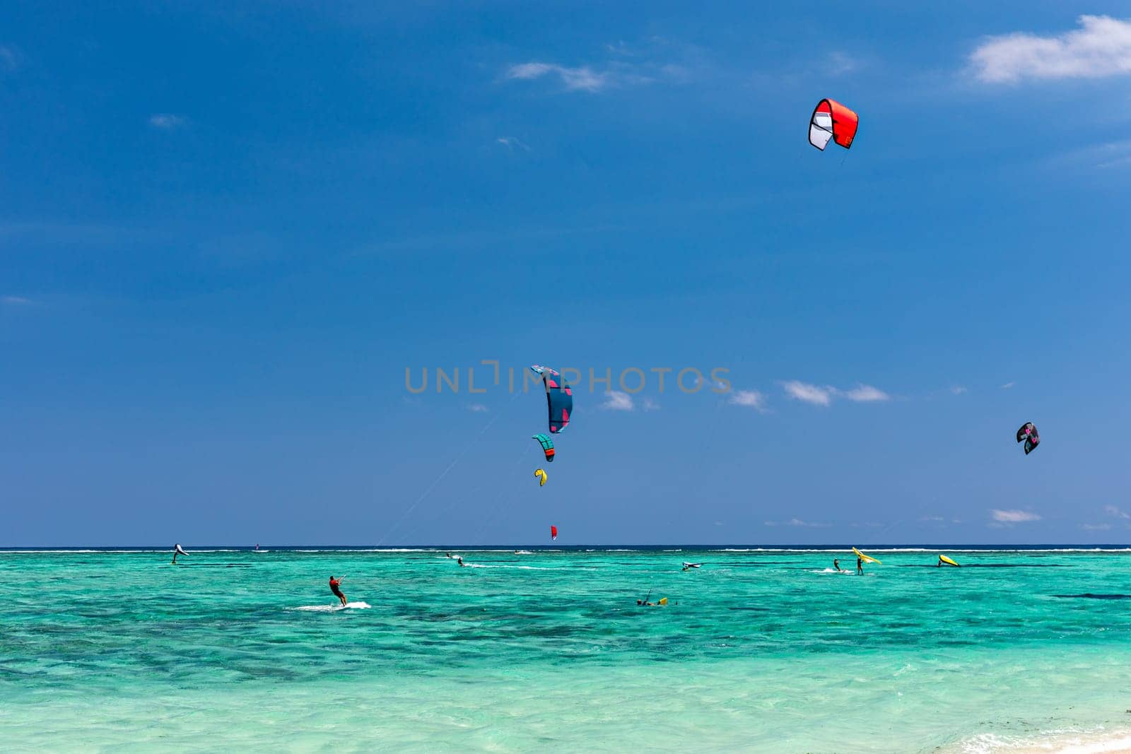 Kite surfers in the waters of Indian Ocean, Mauritius. Kite surfing in the clear waters of the Indian Ocean in Le Morne beach, Mauritius. Best Kite surfing experience at Mauritius island.