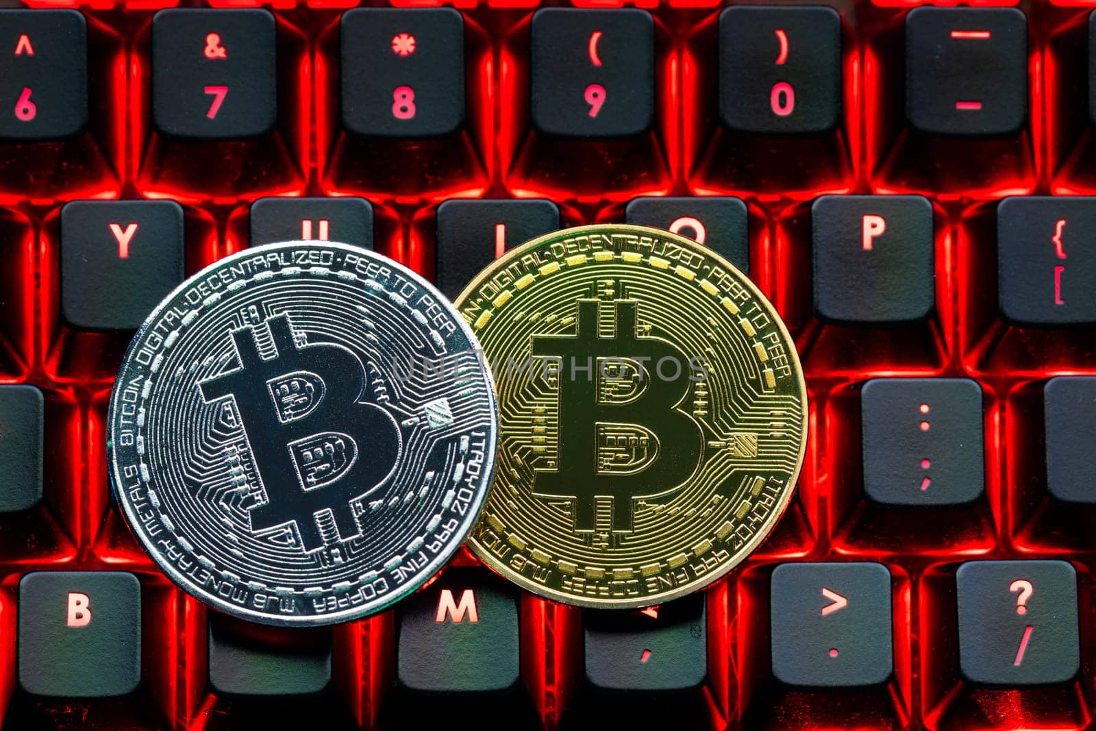 Bitcoin on compuer keyboard in background, symbol of electronic virtual money and mining cryptocurrency concept. Coin crypto currency bitcoin lies on the keyboard. Bitcoin on keyboard.