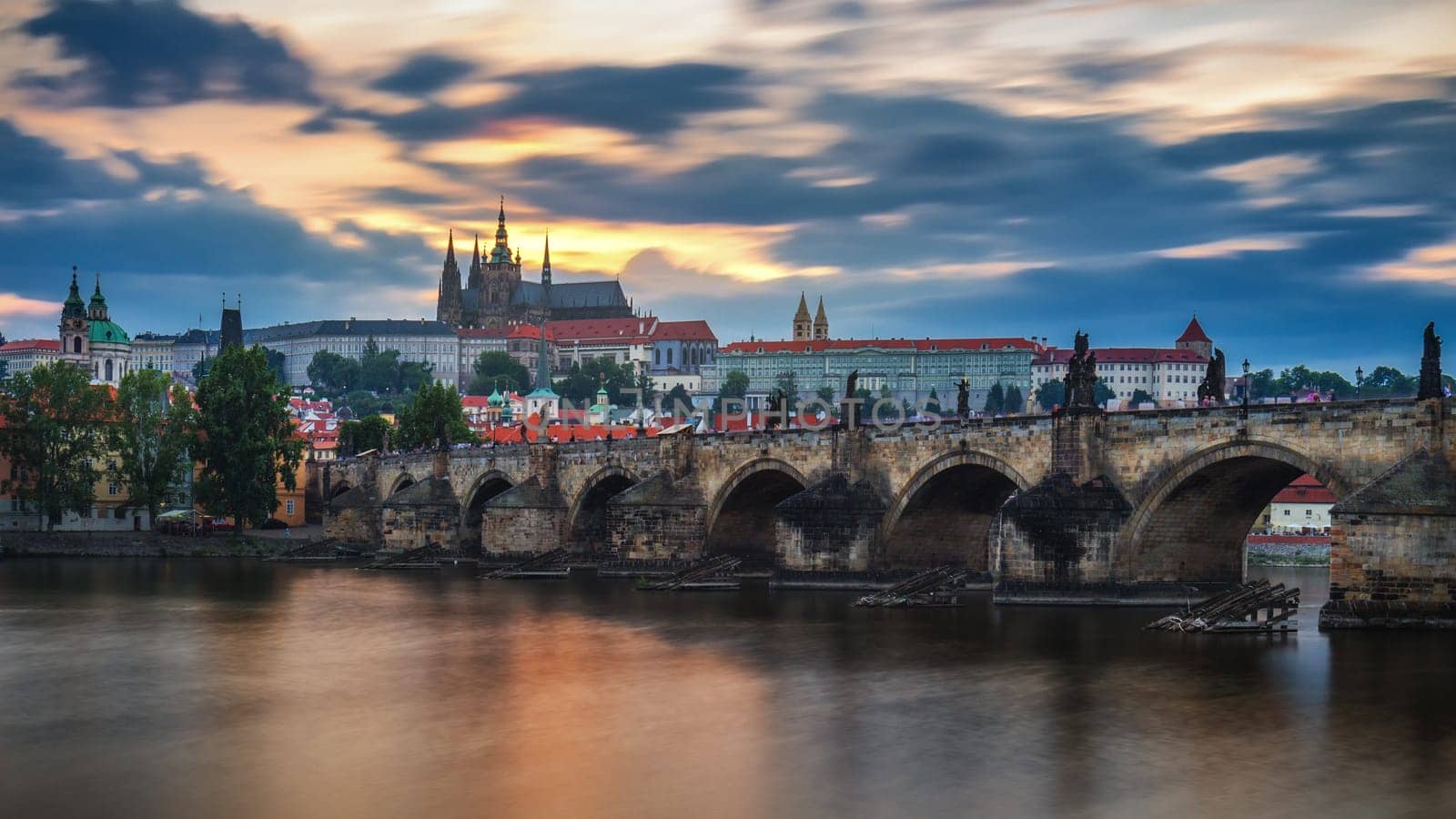 View of Prague Castle and Charles Bridge at sunset. Czechia