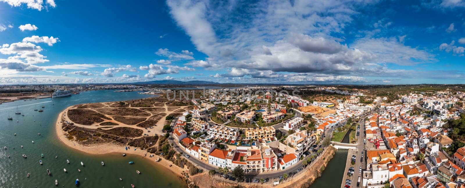 View of Ferragudo village in Algarve, Portugal. Old sea town of Ferragudo. View of Ferragudo from the air. Ferragudo is a beautiful coastal village in Algarve, Portugal, Europe.