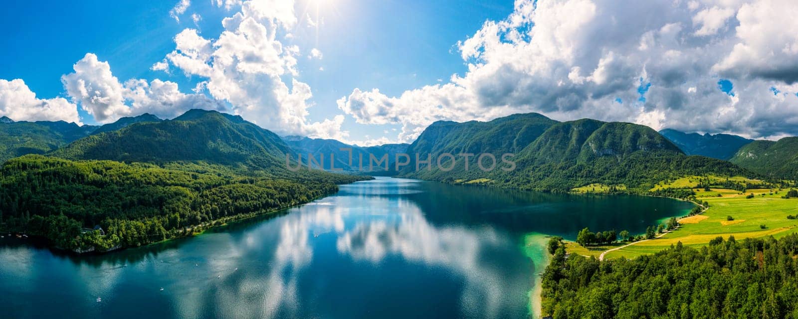 Aerial view of Bohinj lake in Julian Alps. Popular touristic destination in Slovenia. Bohinj Lake, Church of St John the Baptist. Triglav National Park, Julian Alps, Slovenia. 
