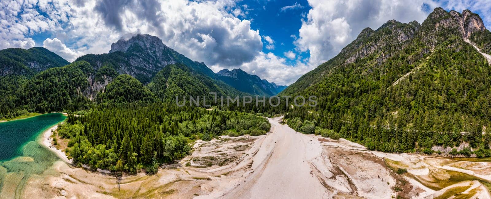 View to Julian Alps mountains above Predil lake in Italy with small lake. Predil Lake, Friuli Italy / (Lago del Predil), beautiful alpine lake in north Italy near the Slovenian border, Italy.