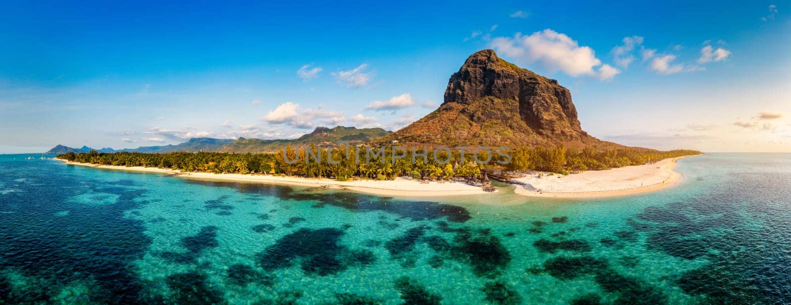 Aerial view of Le morne Brabant in Mauriutius. Tropical crystal ocean with Le Morne mountain and luxury beach in Mauritius. Le Morne beach with palm trees, white sand and luxury resorts, Mauritius.