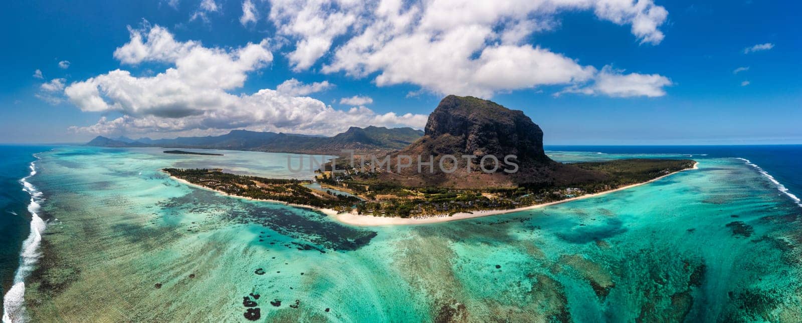 Aerial view of Le morne Brabant in Mauriutius. Tropical crystal ocean with Le Morne mountain and luxury beach in Mauritius. Le Morne beach with palm trees, white sand and luxury resorts, Mauritius.