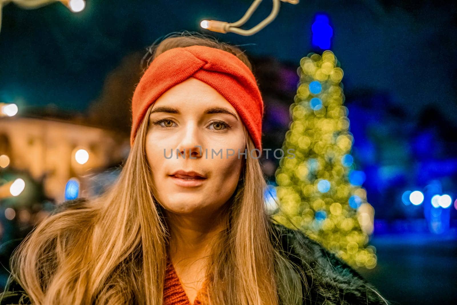 Winter fun on the street: Girl with sparklers, smiles in warm jacket and hat. Festive Christmas or New Year celebration,