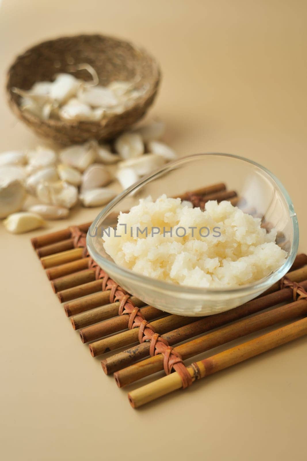 close up of minced garlic on a wooden spoon ,