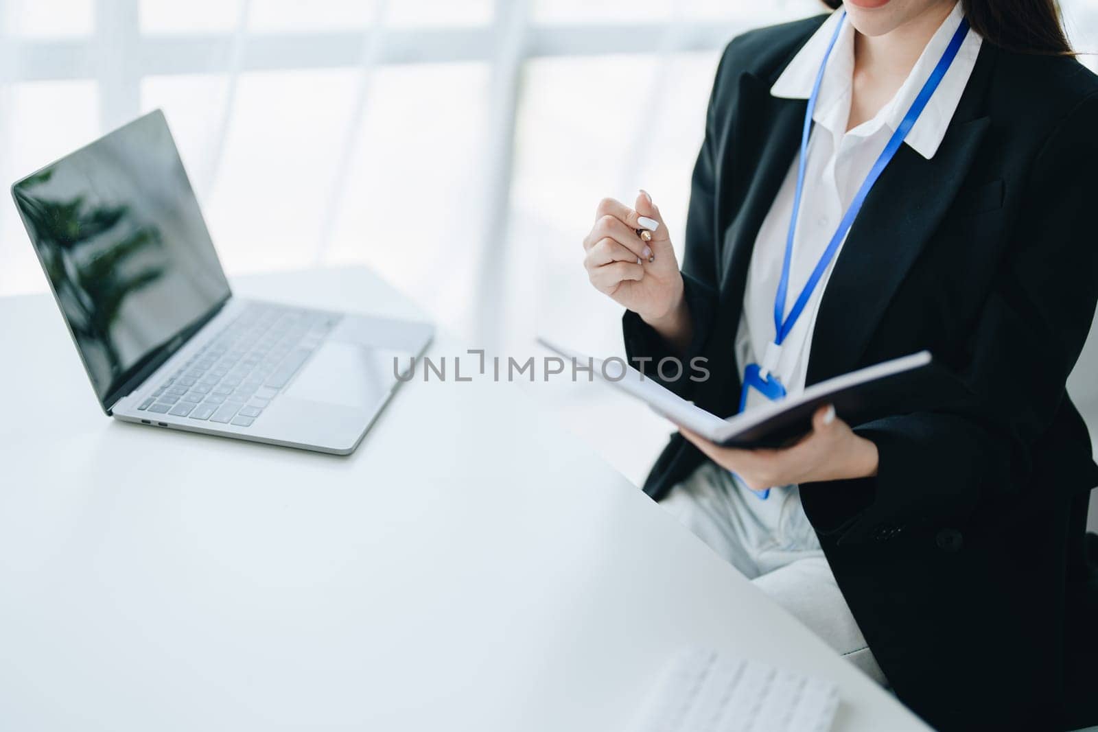 Consultant, advisor, Asian business woman working on the tablet computer work financial and marketing business plan to increase company profits, ready to use computer and marketing planning documents.