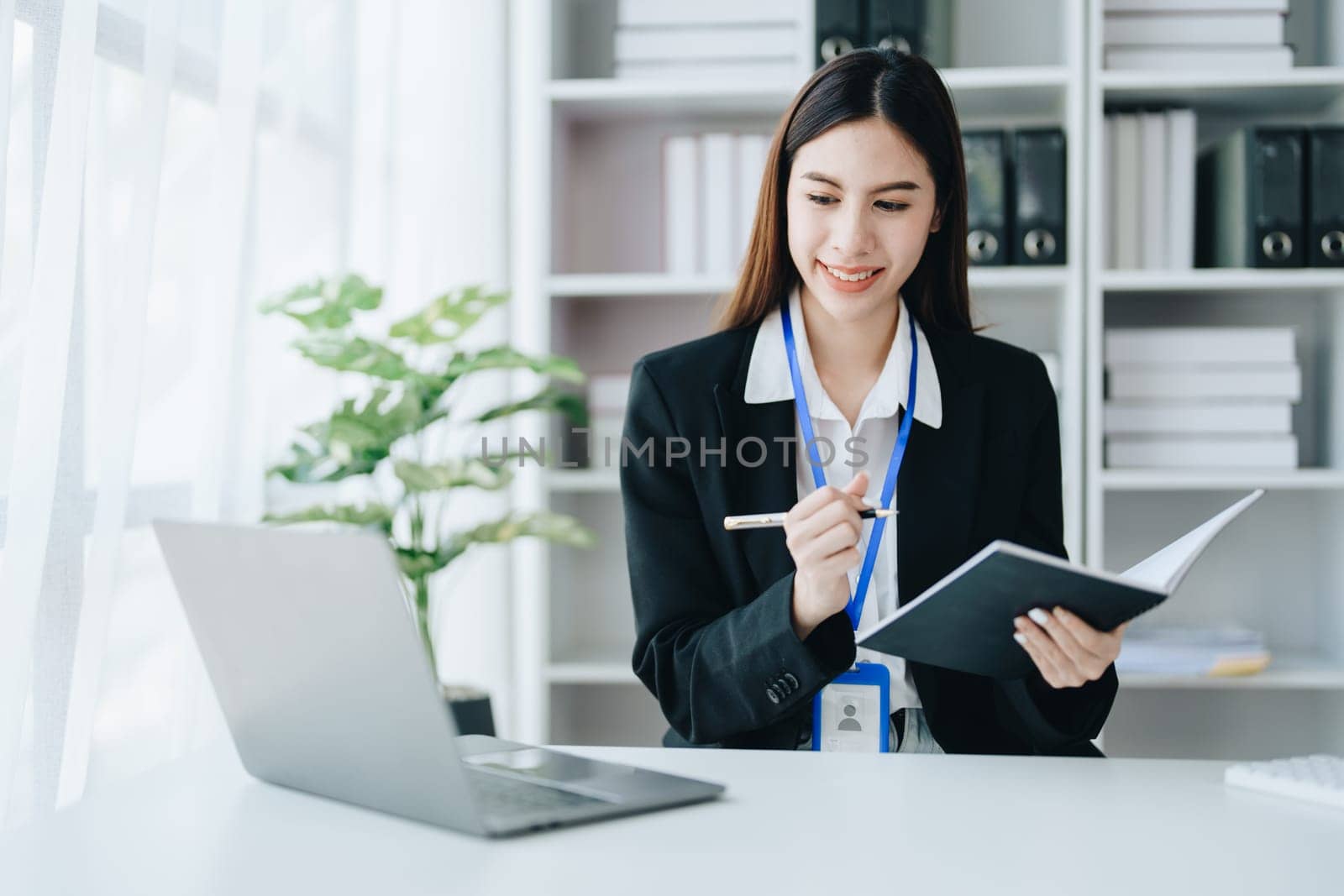 Consultant, advisor, Asian business woman working on the tablet computer work financial and marketing business plan to increase company profits, ready to use computer and marketing planning documents by Manastrong