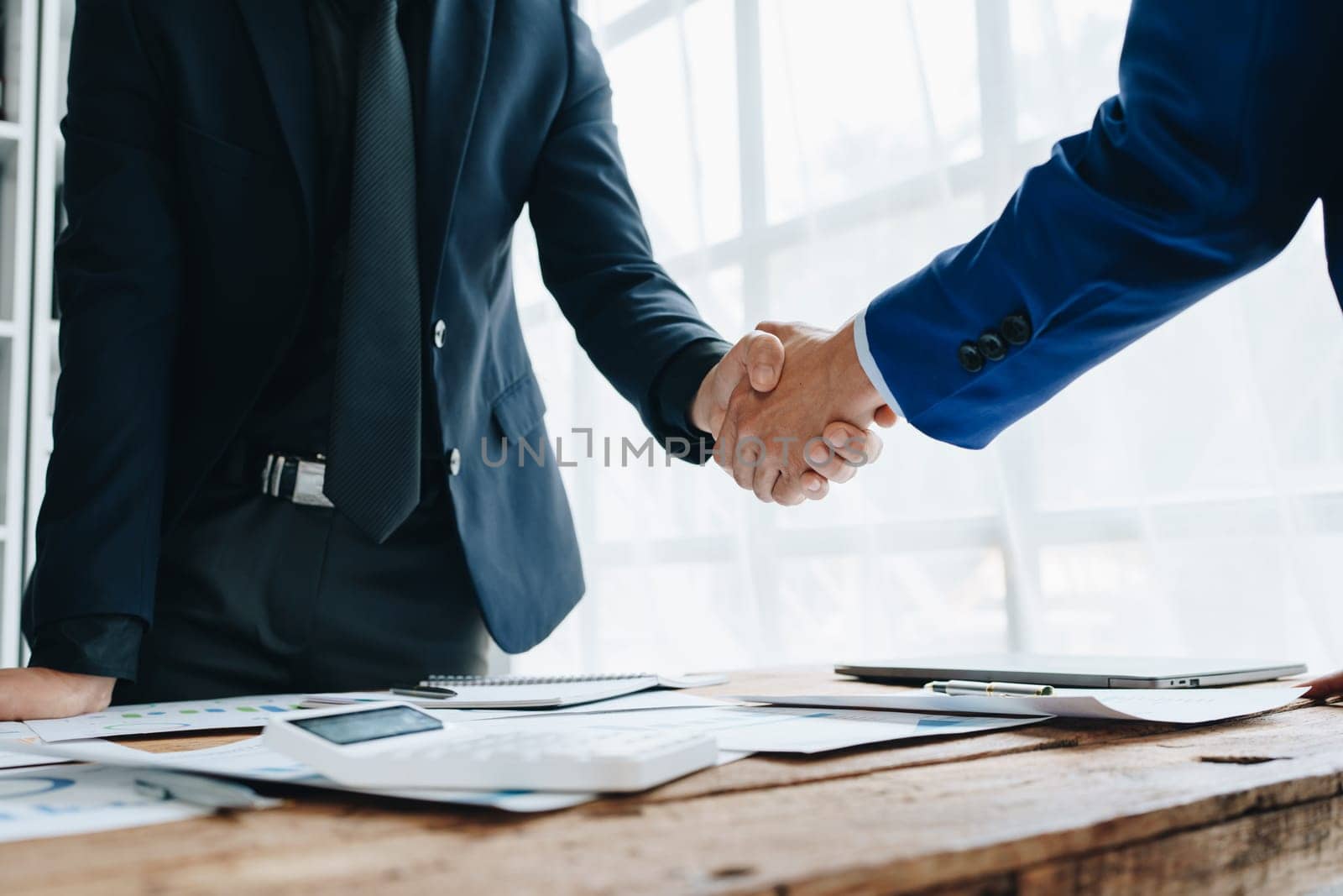 Young businesswoman and businessman collaborate with partners to increase their business investment network for Plans to improve quality next month in their office. agreement concept