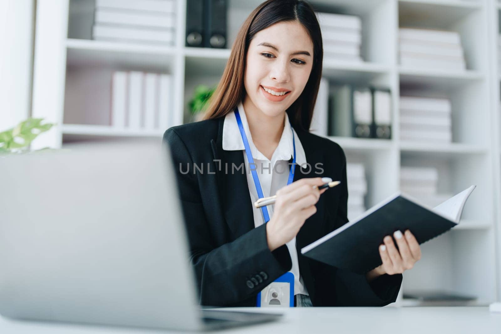 Consultant, advisor, Asian business woman working on the tablet computer work financial and marketing business plan to increase company profits, ready to use computer and marketing planning documents.