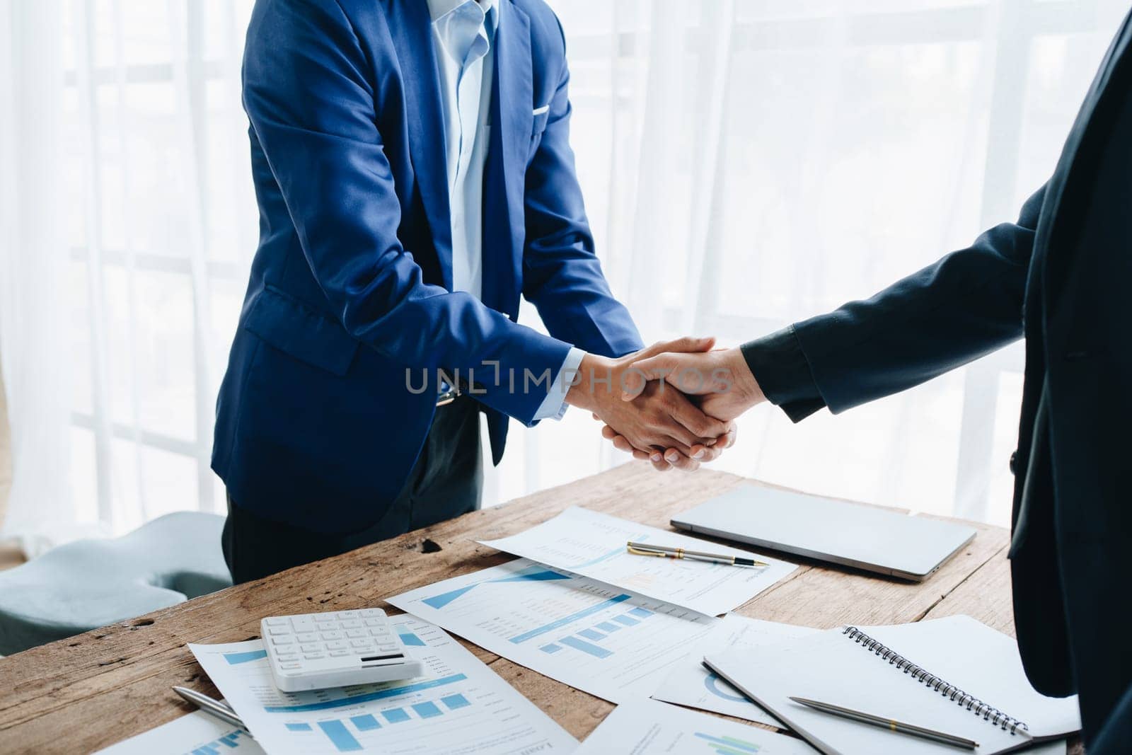 Young businesswoman and businessman collaborate with partners to increase their business investment network for Plans to improve quality next month in their office. agreement concept