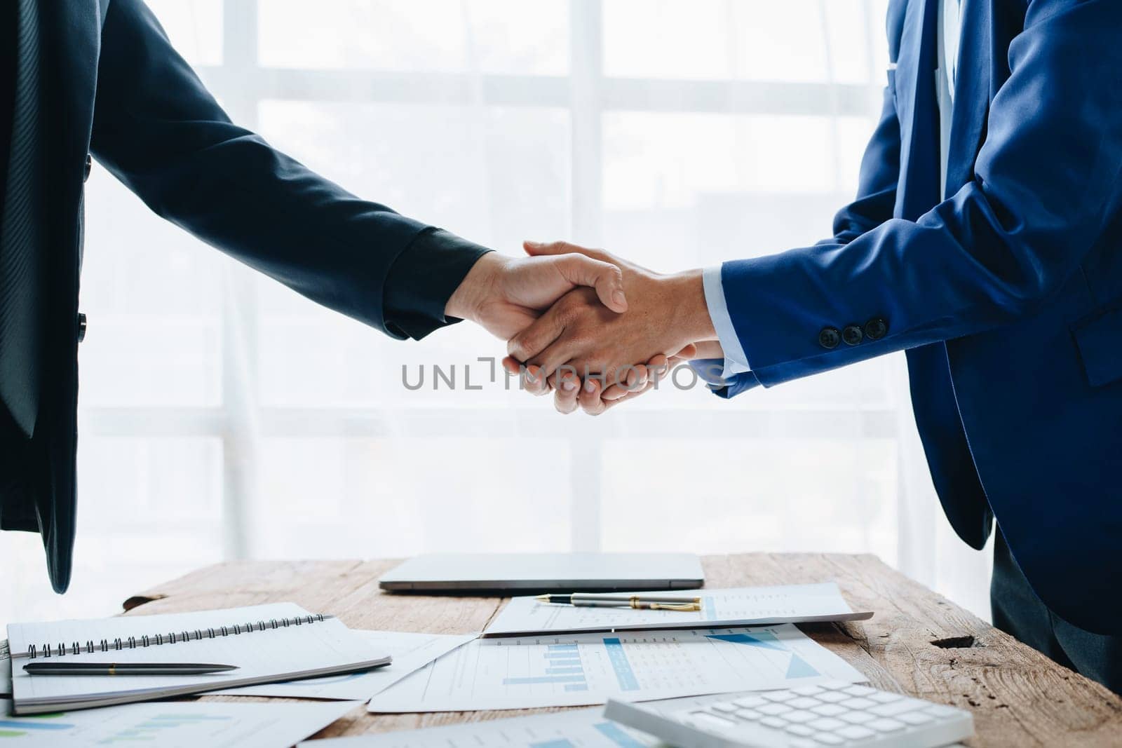 Young businesswoman and businessman collaborate with partners to increase their business investment network for Plans to improve quality next month in their office. agreement concept