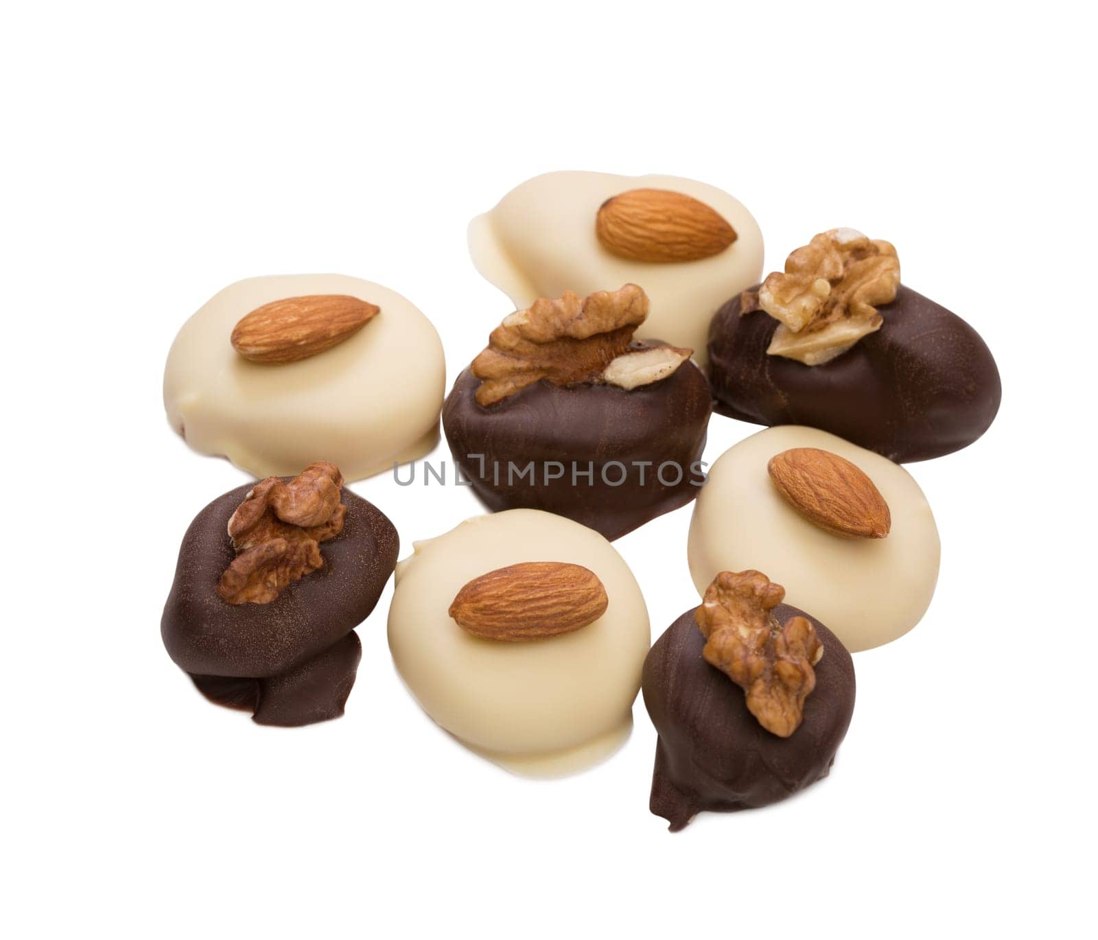 Delicious chocolate candies with nuts, isolated on white