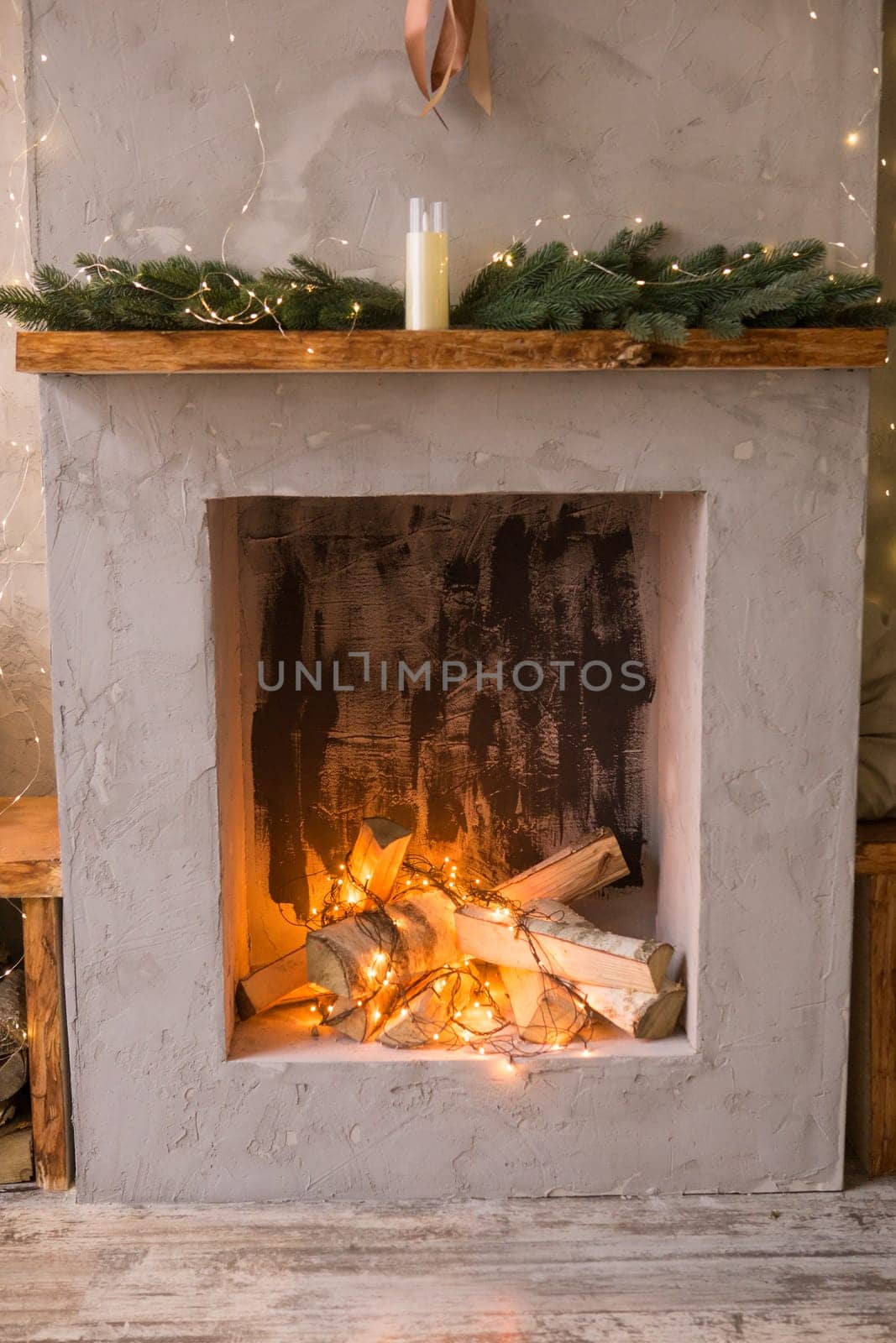 Fireplace decorated for Christmas. The interior of the Scandinavian-style living room, decorated for the Christmas holidays