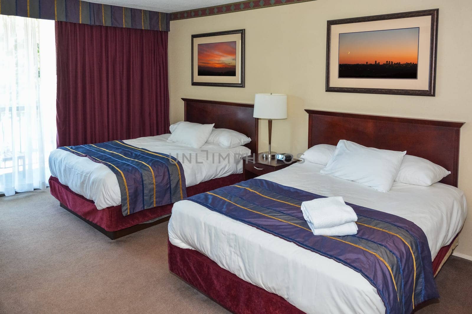 Two made up beds in a hotel room