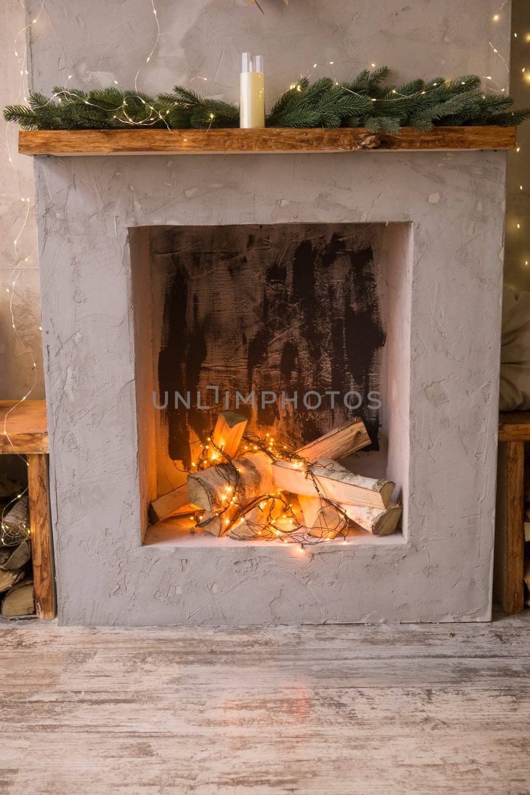 Fireplace decorated for Christmas. The interior of the Scandinavian-style living room, decorated for the Christmas holidays