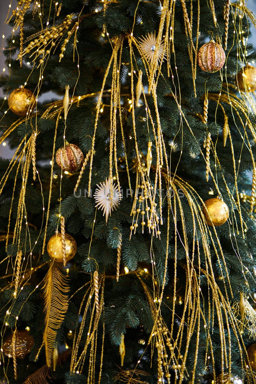 Close up of decorated Christmas tree with golden baubles and ornaments. Shallow Depth of Field