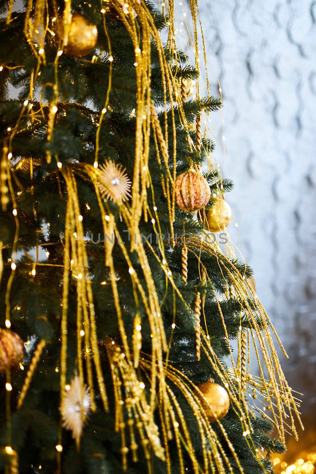 Close up of decorated Christmas tree with golden baubles and ornaments. Shallow Depth of Field